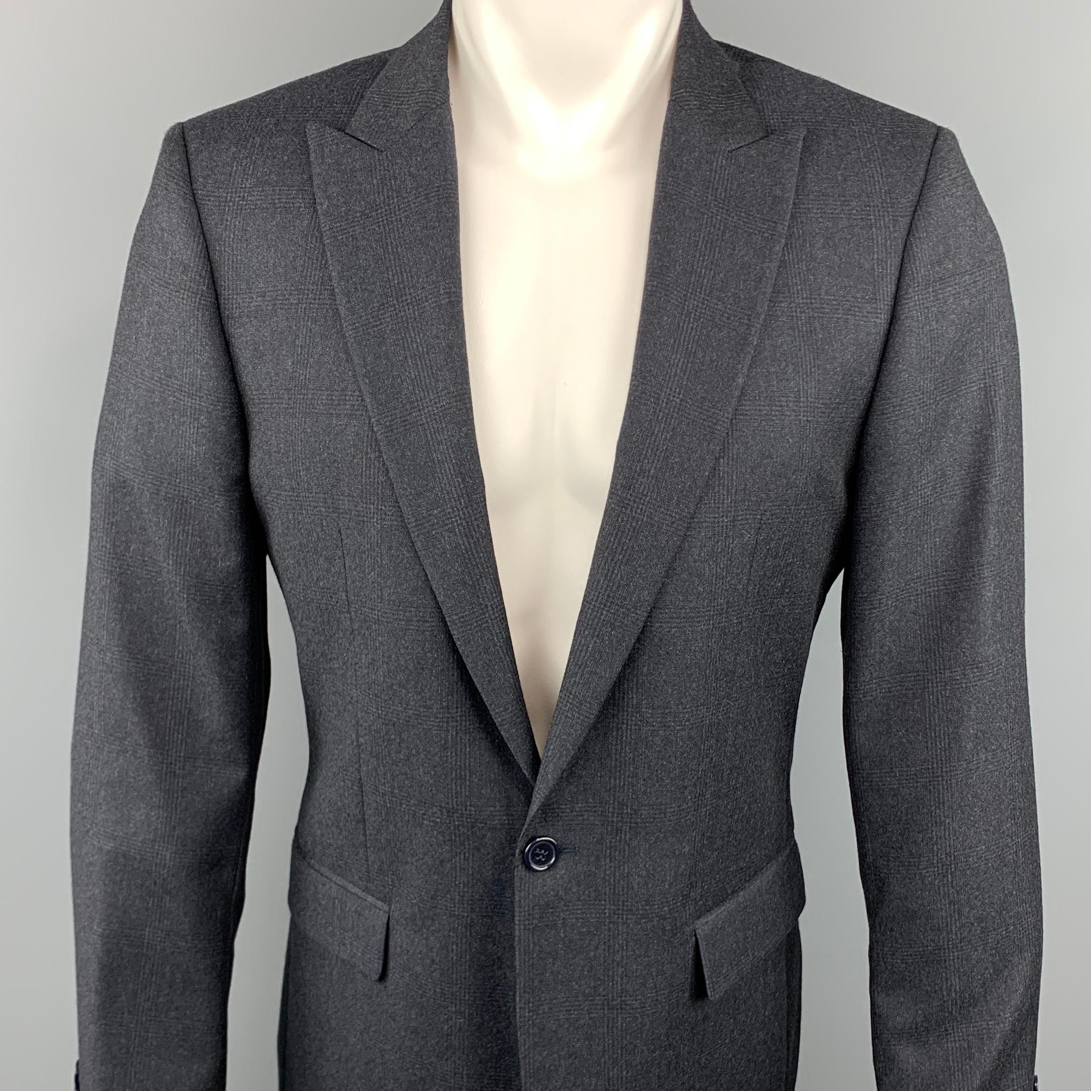 CALVIN KLEIN COLLECTION sport coat comes in a charcoal glenplaid wool featuring a peak lapel style, single button closure, and front flap pockets.
 
Excellent Pre-Owned Condition.
Marked: 48
 
Measurements:
 
Shoulder: 16.5 in.
Chest: 36 in.
Sleeve: