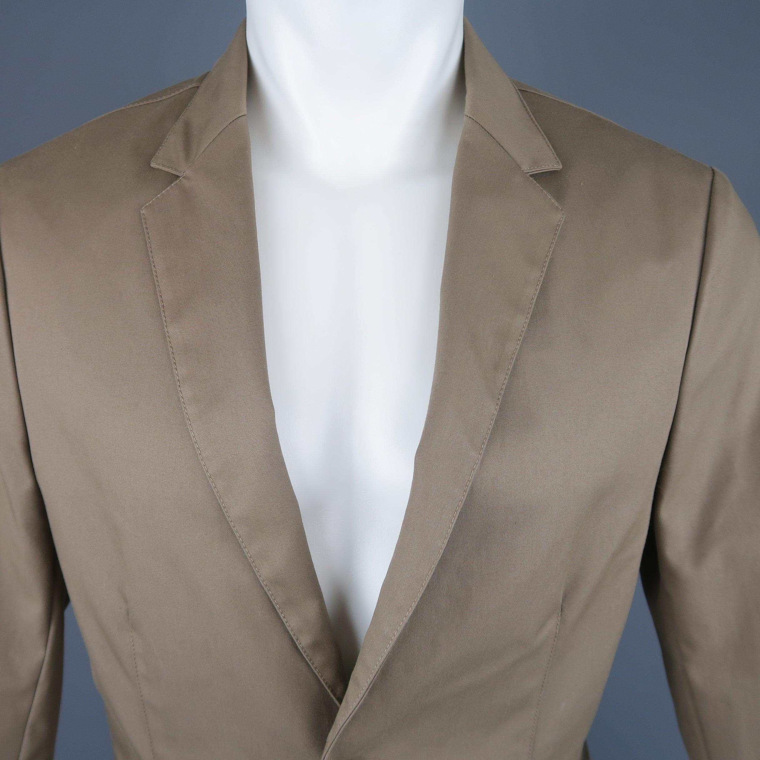 Single breasted CALVIN KLEIN COLLECTION monochromatic sport coat jacket comes in taupe cotton blend structured fabric with a notch lapel, two button front, and ventless back. Made in Italy.New with tags
 

Marked:   IT 48
 

Measurements: 
