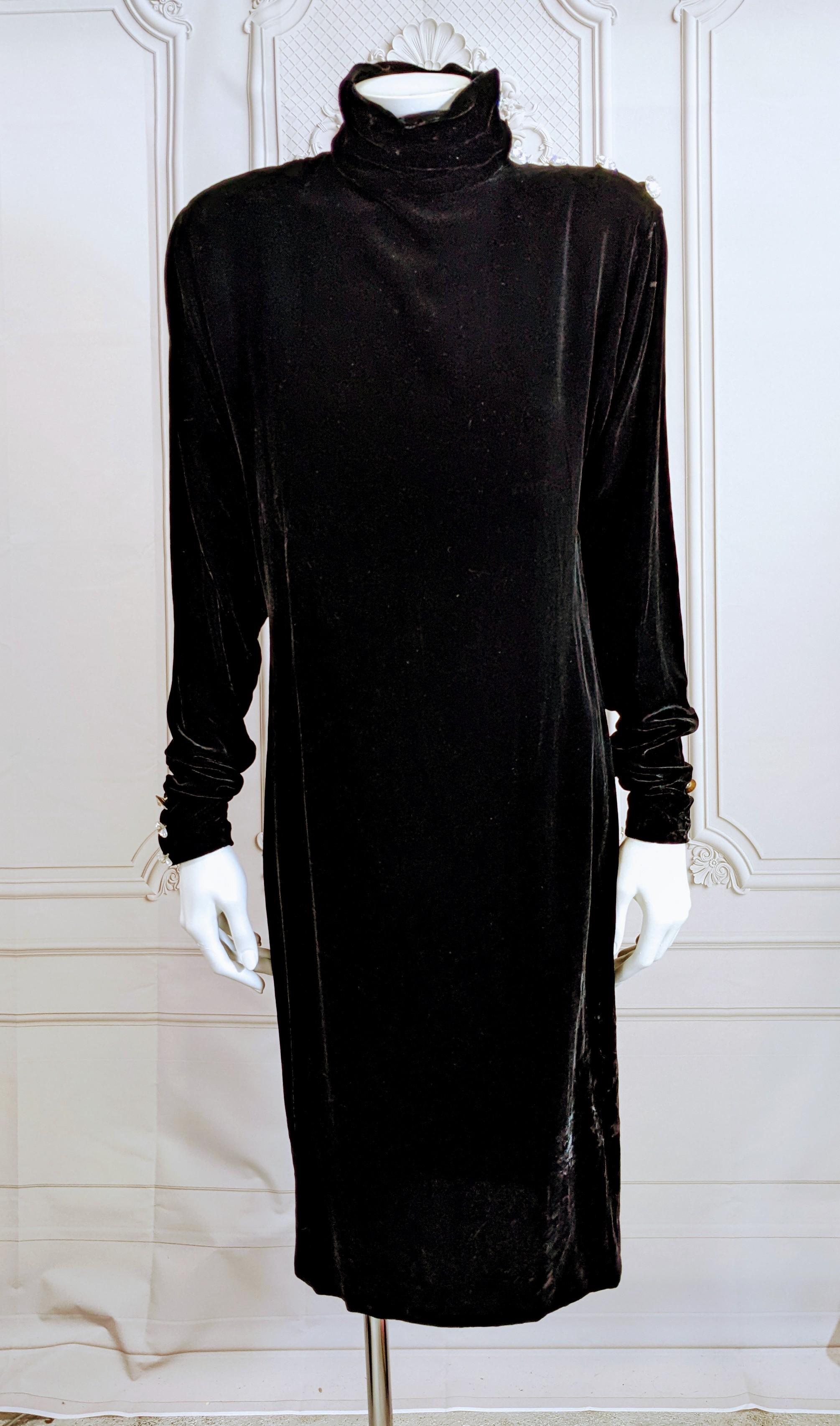 Calvin Klein Collection Diamonte Ink Black Velvet Sheath with strong shoulders and bias turtleneck collar studded with large Swarovski crystals with satin loops along shoulder line and along cuffs. Sleeves are long to pool. Cuffs have hidden snap