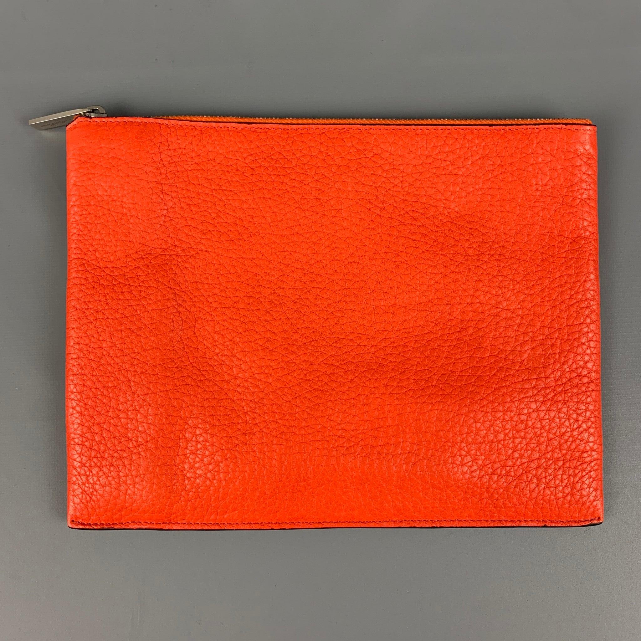 CALVIN KLEIN COLLECTION pouch bag comes in a orange textured leather featuring a top zipper closure. Made in Italy.
 Very Good
 Pre-Owned Condition. 
 

 Measurements: 
  Length: 10.5 inches Height:
 8 inches 
  
  
  
 Sui Generis Reference: