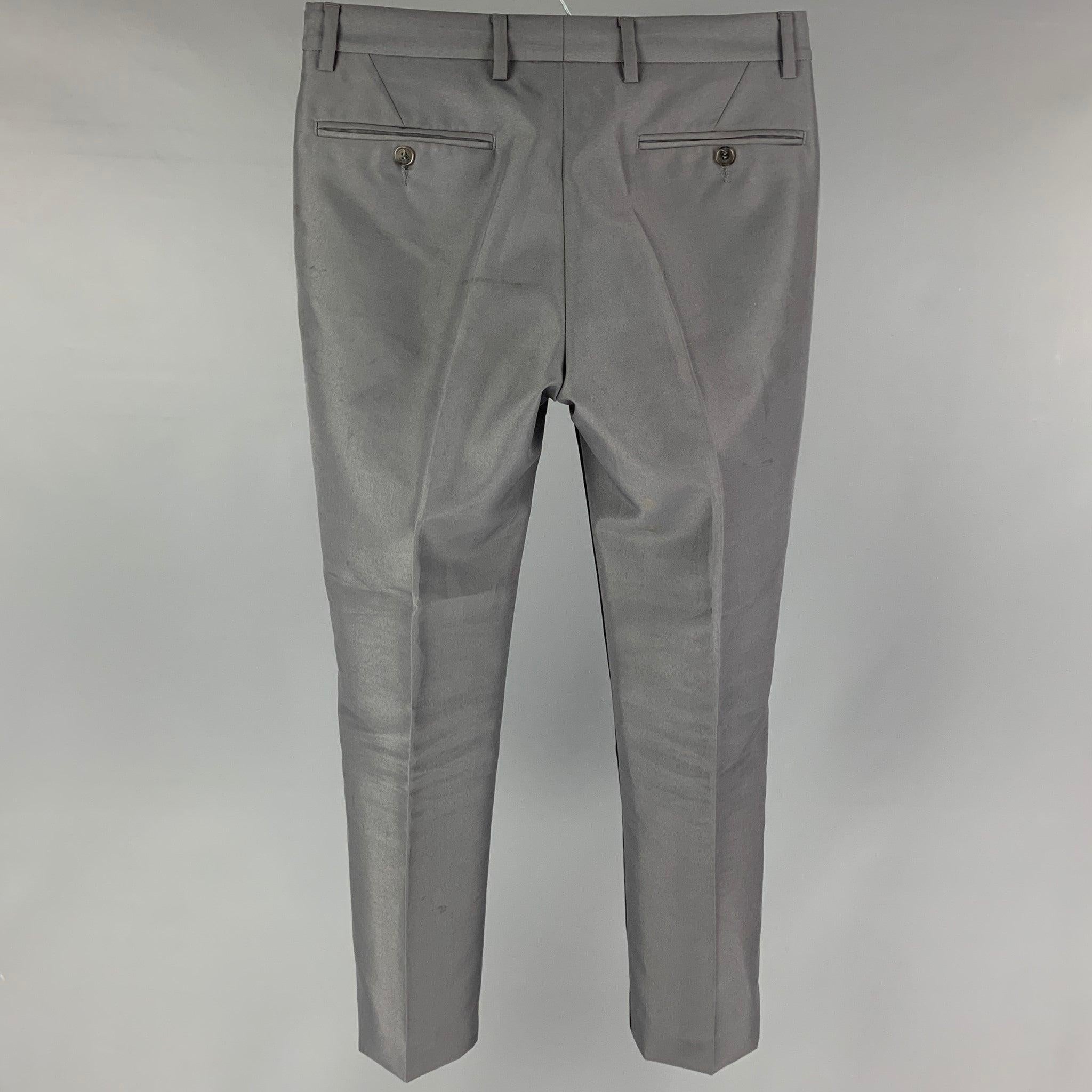CALVIN KLEIN COLLECTION dress pants comes in a grey & navy dyed print polyamide featuring a slim fit, flat front, and a zip fly closure. Made in Italy.
Good
Pre-Owned Condition. Minor discoloration at front.  

Marked:   44/28 

Measurements: 
 
