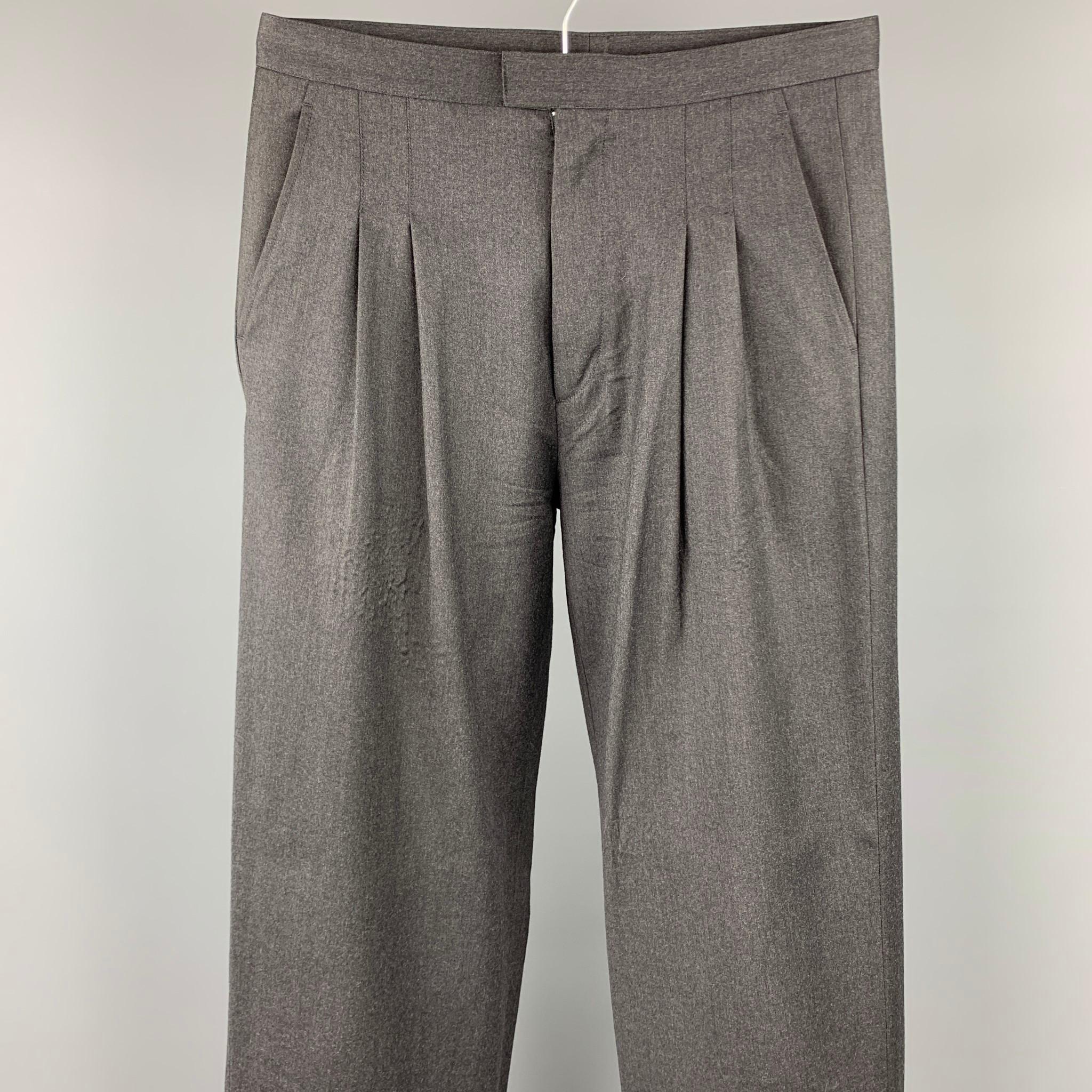 CALVIN KLEIN COLLECTION dress pants comes in a charcoal wool featuring a pleated style, front tab, and a zip fly closure. 

Very Good Pre-Owned Condition.
Marked: 46/30

Measurements:

Waist: 32 in.
Rise: 11.5 in.
Inseam: 31 in. 