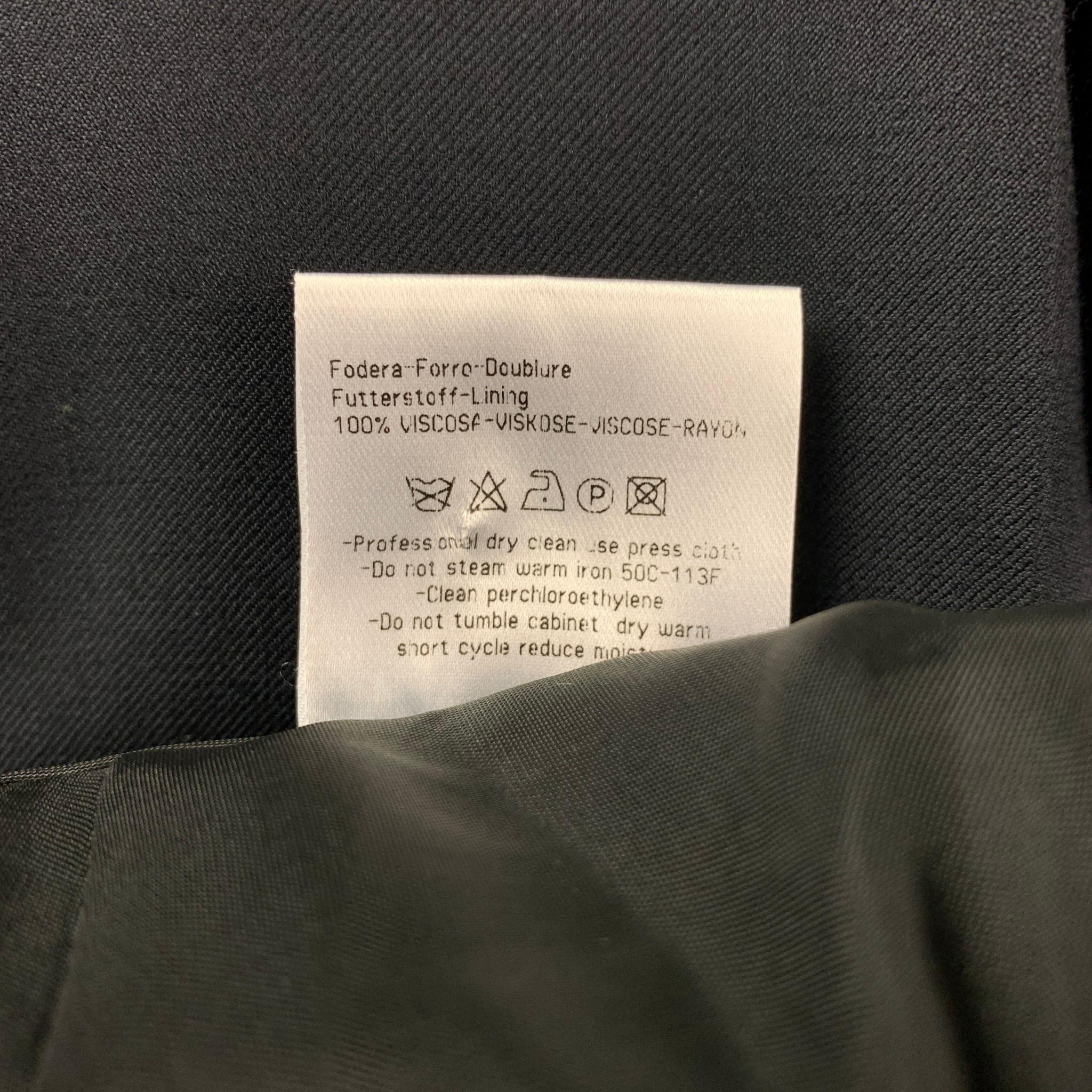CALVIN KLEIN COLLECTION dress pants comes in a navy wool featuring a flat front, slit pockets, front tab, and a zip fly closure. 

Very Good Pre-Owned Condition.
Marked: 52/41

Measurements:

Waist: 34 in.
Rise: 10 in.
Inseam: 30 in. 