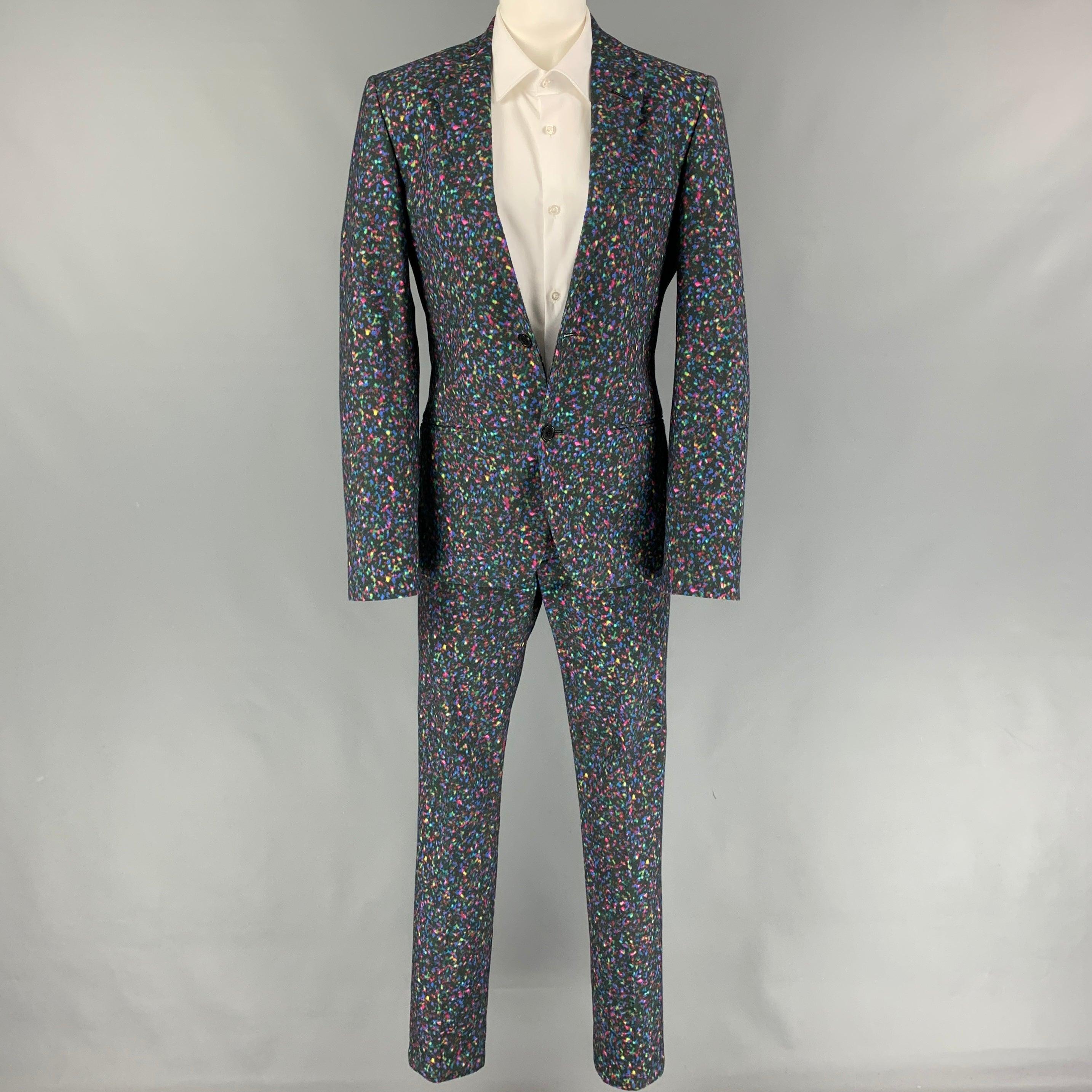 CALVIN KLEIN COLLECTION
suit comes in a multi-color print cotton and includes a single breasted, double button sport coat with a notch lapel and matching flat front trousers. Very Good Pre-Owned Condition. 

Marked:   44/34 

Measurements: 
 