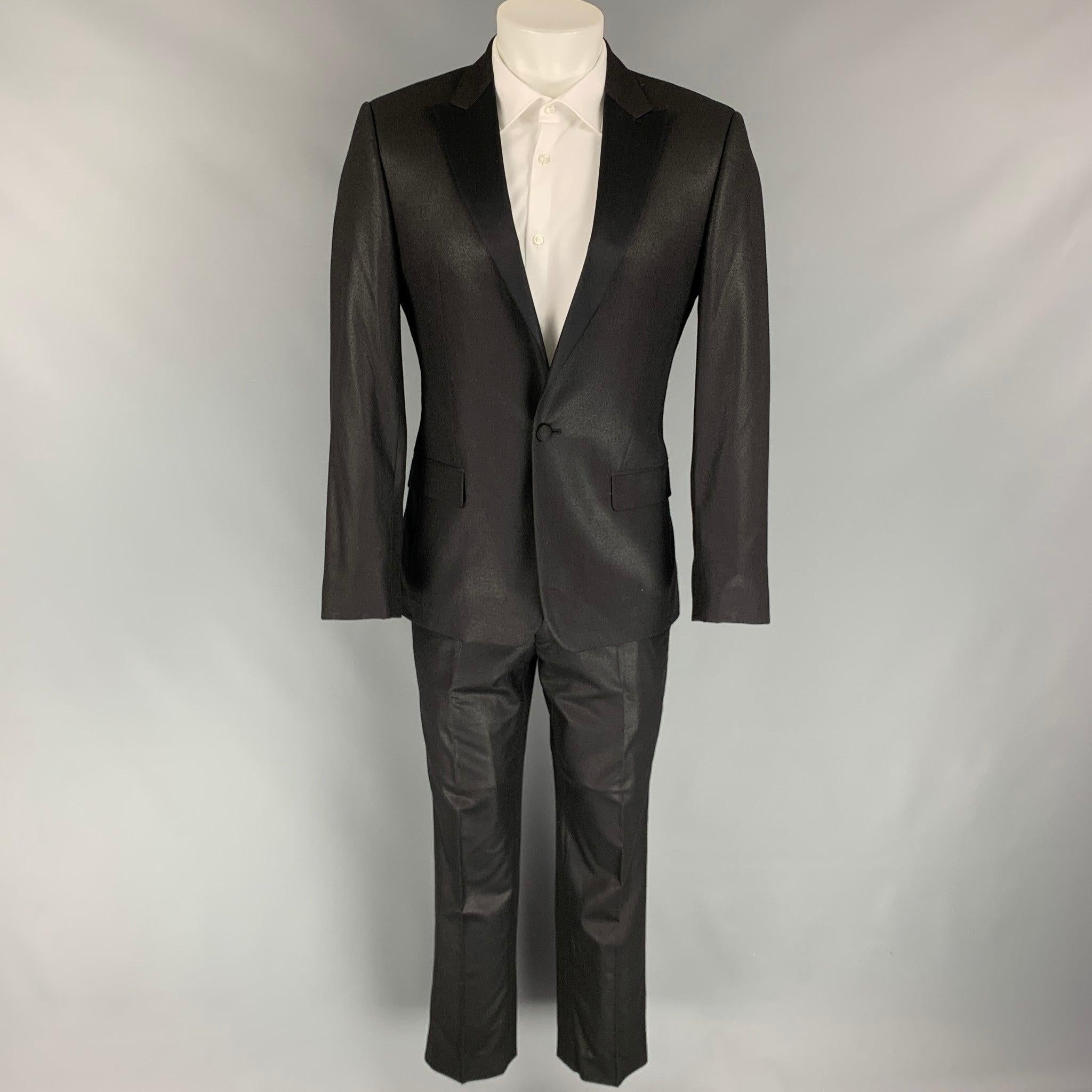 CALVIN KLEIN COLLECTION tuxedo
suit comes in a black sparkle wool with a full liner and includes a single breasted, single button sport coat with a peak lapel and matching flat front trousers. New With Tags.  

Marked:   46/36 

Measurements: 
 
