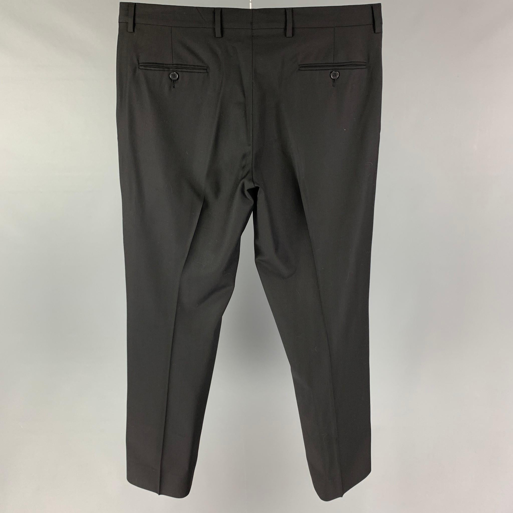CALVIN KLEIN dress pants comes in a black wool featuring a flat front and a zip fly closure. 

Very Good Pre-Owned Condition.
Marked: 52/41

Measurements:

Waist: 36 in.
Rise: 10 in.
Inseam: 30 in. 