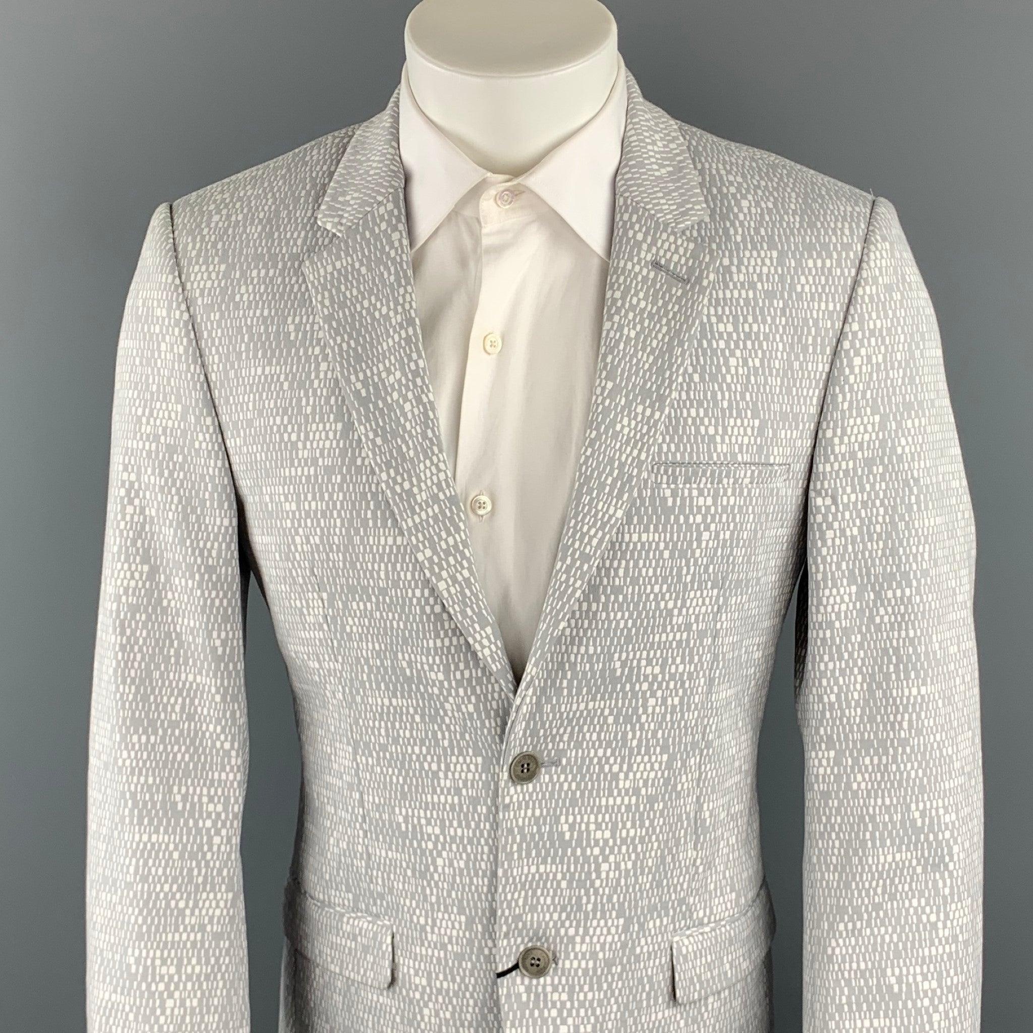 CALVIN KLEIN COLLECTION sport coat comes in a gray & white woven cotton blend with a full liner featuring a notch lapel, flap pockets, and a two button closure.New With Tags. 

Marked:   46/36 

Measurements: 
 
Shoulder: 17.5 inches 
Chest: 38