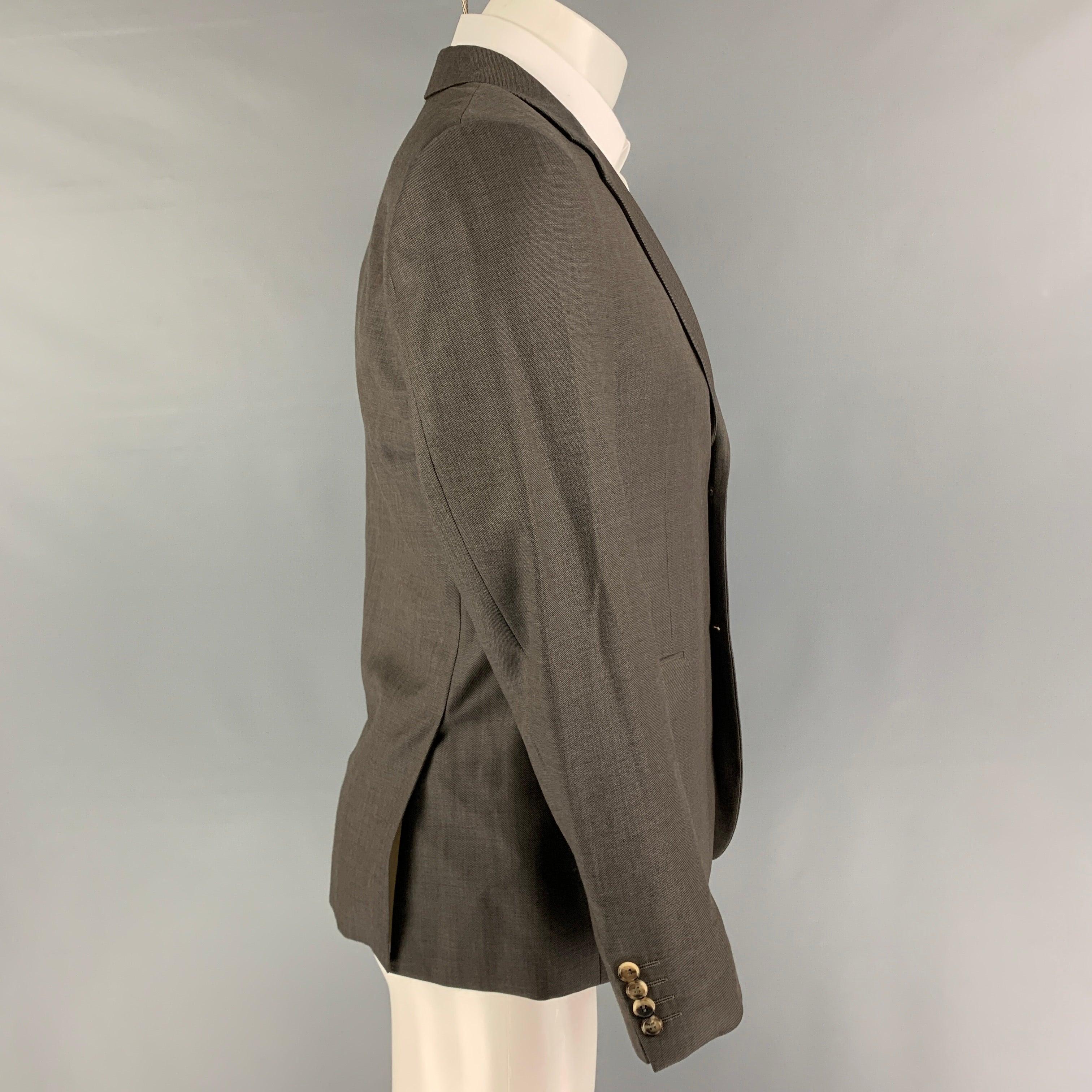 CALVIN KLEIN COLLECTION sport coat comes in a grey wool with a full liner featuring a notch lapel, flap pockets, double back vent, and a double button closure.
Very Good
Pre-Owned Condition. 

Marked:   46/36 

Measurements: 
 
Shoulder: 17.5 inches