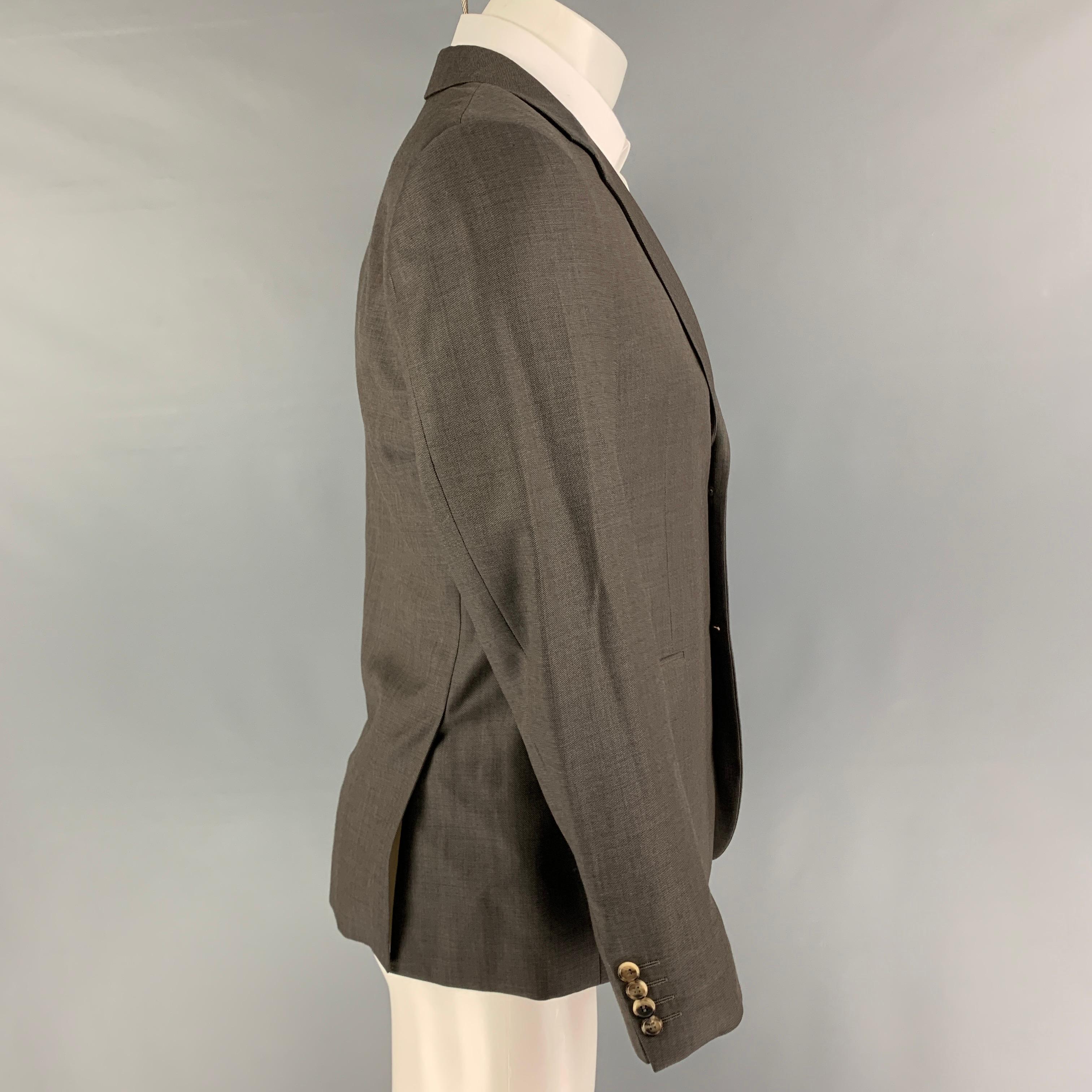 CALVIN KLEIN COLLECTION sport coat comes in a grey wool with a full liner featuring a notch lapel, flap pockets, double back vent, and a double button closure. 

Very Good Pre-Owned Condition.
Marked: 46/36

Measurements:

Shoulder: 17.5 in.
Chest: