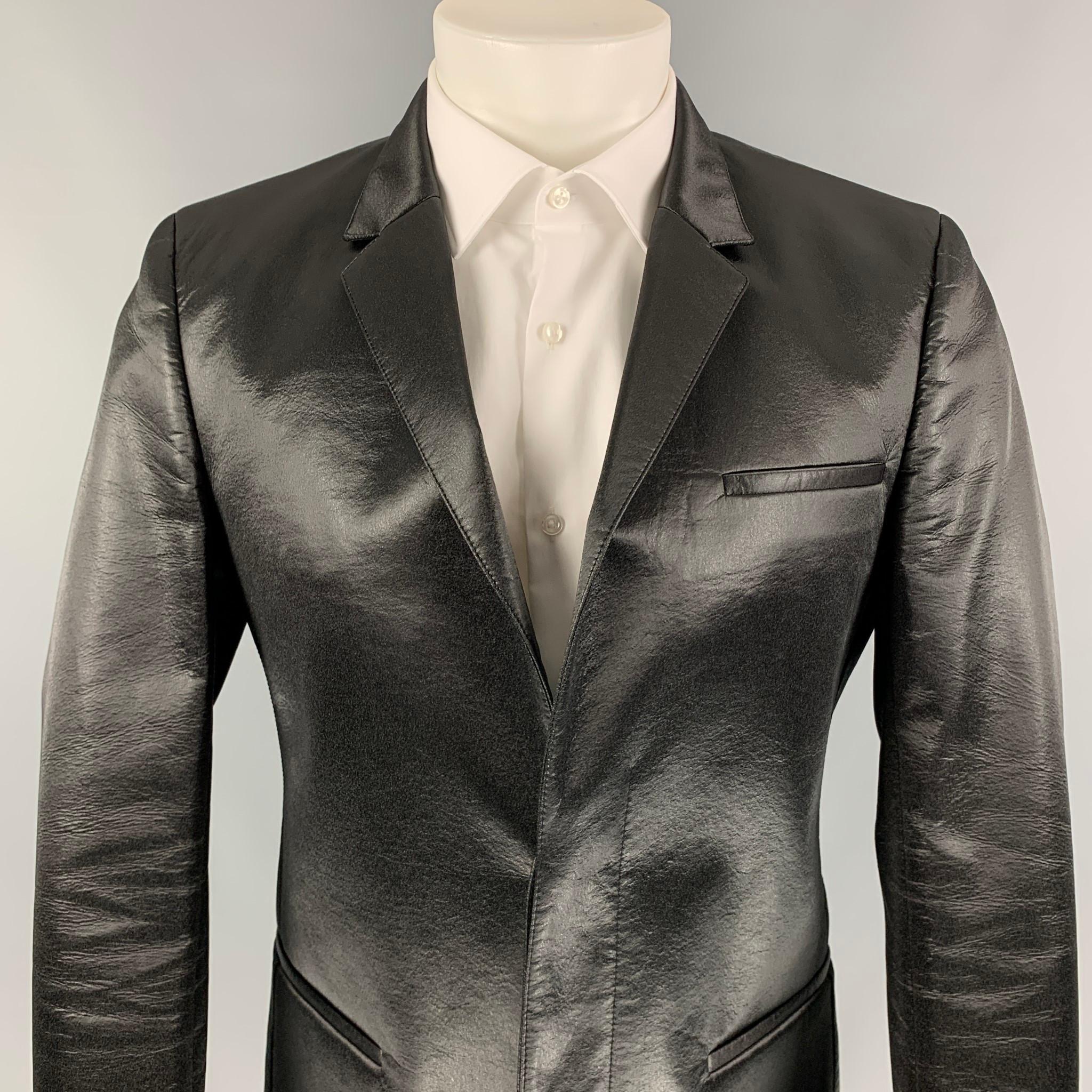 CALVIN KLEIN Collection sport coat comes in a black textured wool / spandex with a full liner featuring a notch lapel, slit pockets, double back vent, and a hidden double button closure. Made in Italy. 

Excellent Pre-Owned Condition.
Marked: