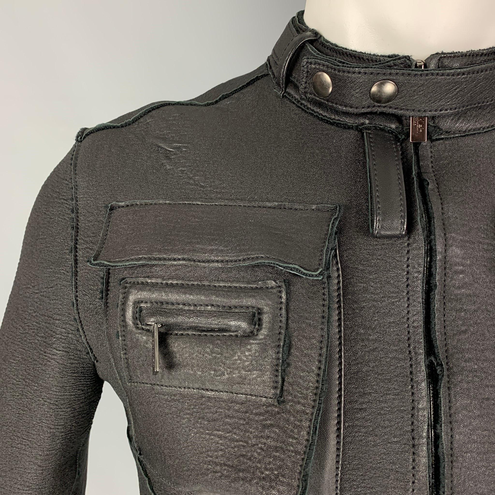 CALVIN KLEIN COLLECTION jacket comes in a black leather with a full liner featuring a motorcycle style, multiple front pockets, removable front collar strap, and a full zip up closure. Made in Italy. 

Very Good Pre-Owned Condition.
Marked: