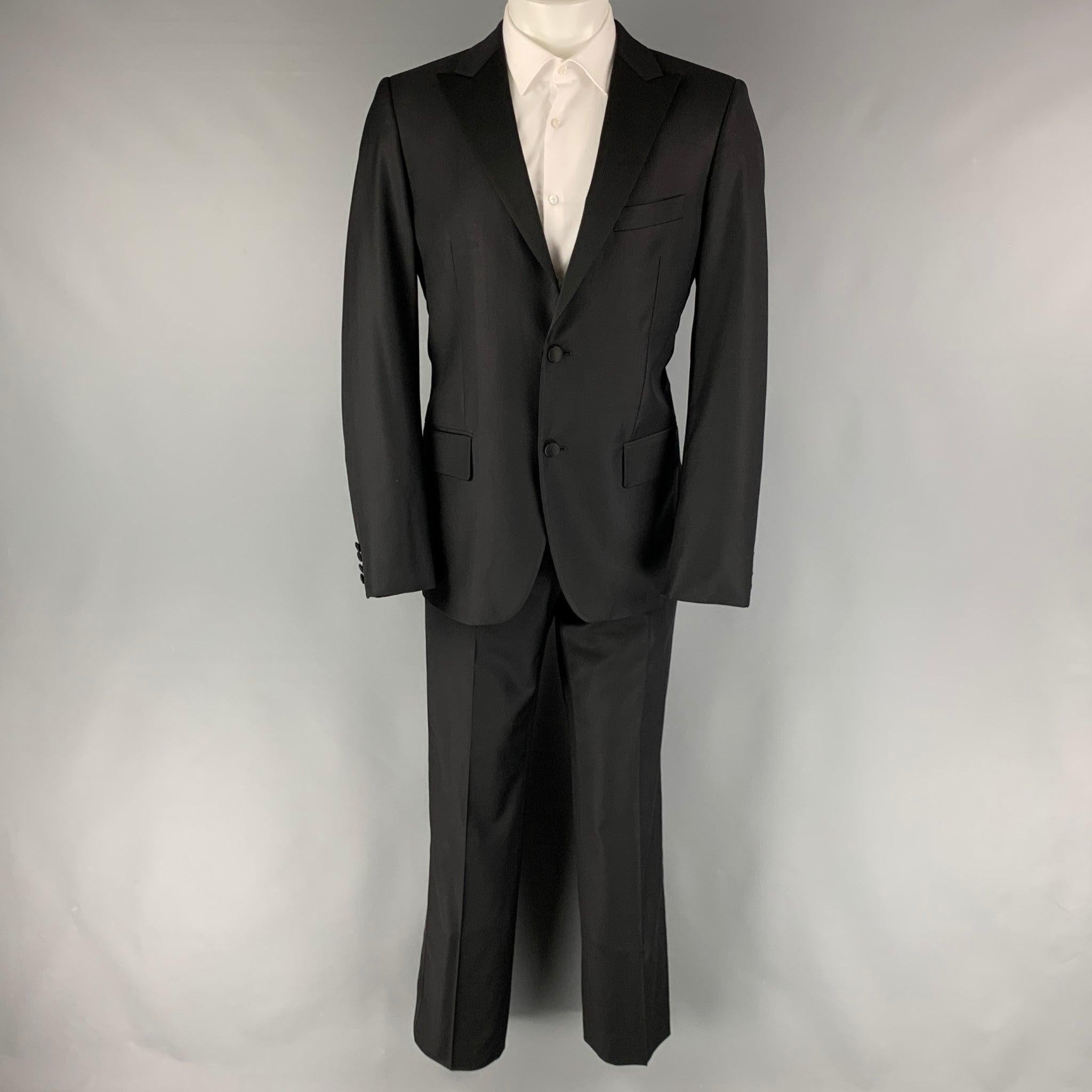 CALVIN KLEIN COLLECTION tuxedo comes in a black wool with a full liner and includes a single breasted, two buttons sport coat with a peak lapel and matching flat front trousers. Excellent Pre-Owned Condition. 

Marked:   48 

Measurements: 
 