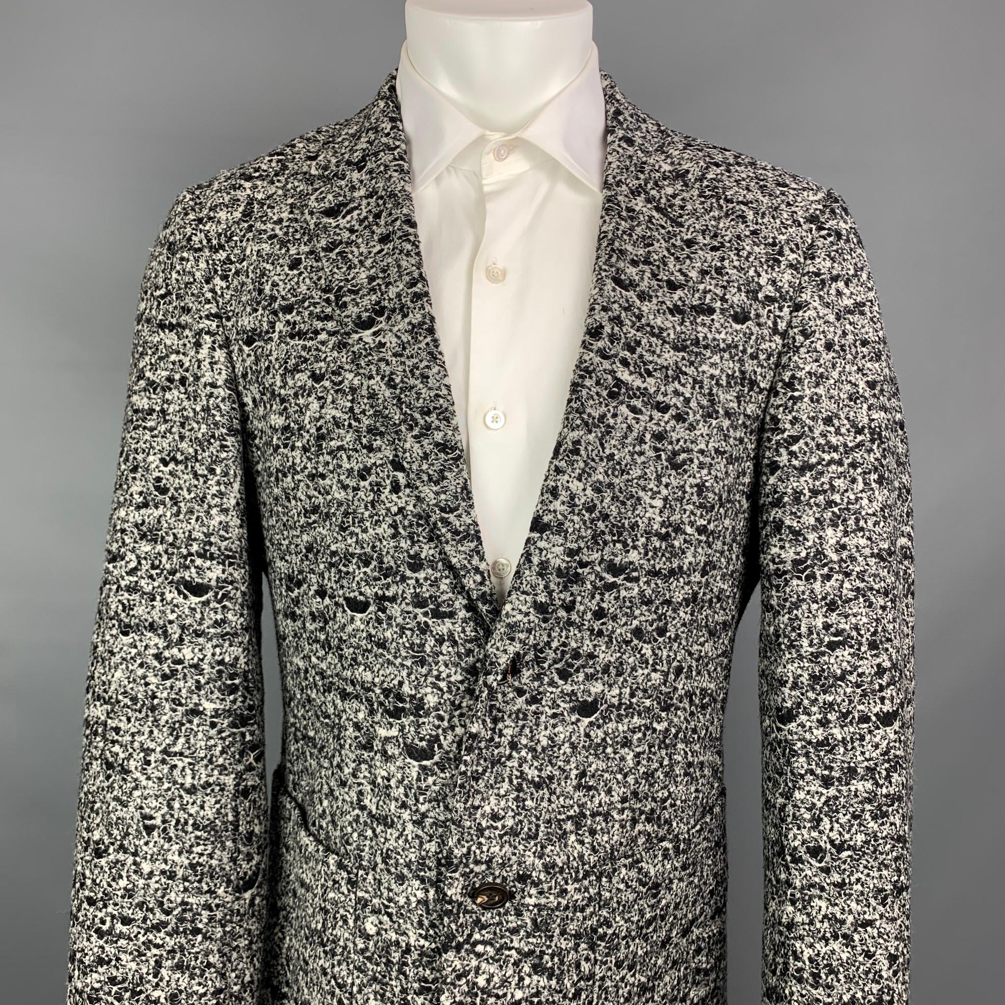 CALVIN KLEIN COLLECTION sport coat comes in a black & white tweed wool / polyamide with a half liner featuring a notch lapel, patch pockets, and a two button closure. Made in Italy.

Very Good Pre-Owned Condition.
Marked:
