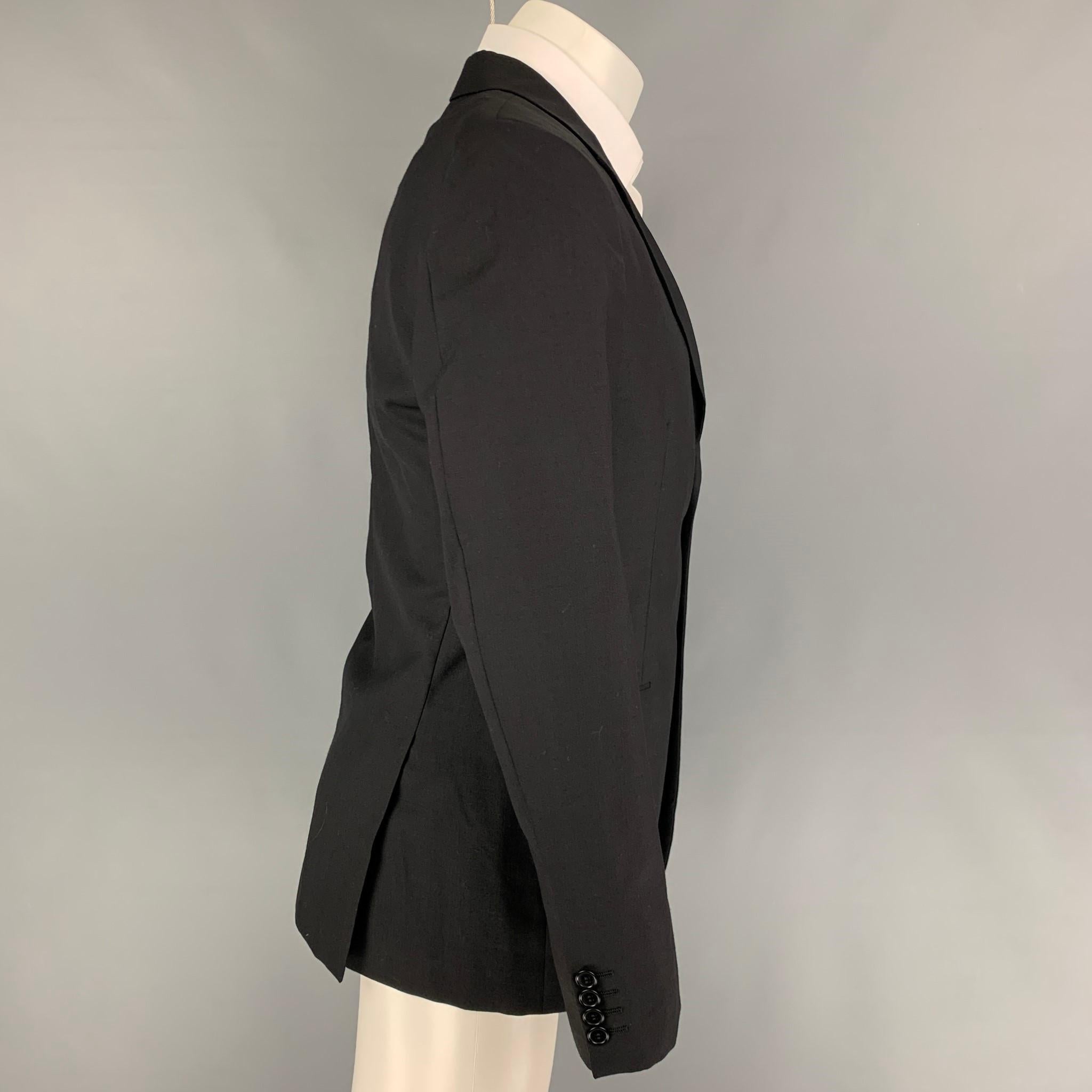 CALVIN KLEIN COLLECTION sport coat comes in a black wool with a full liner featuring a notch lapel, flap pockets, double back vent, and a double button closure. 

Very Good Pre-Owned Condition.
Marked: 48/38

Measurements:

Shoulder: 17.5 in.
Chest: