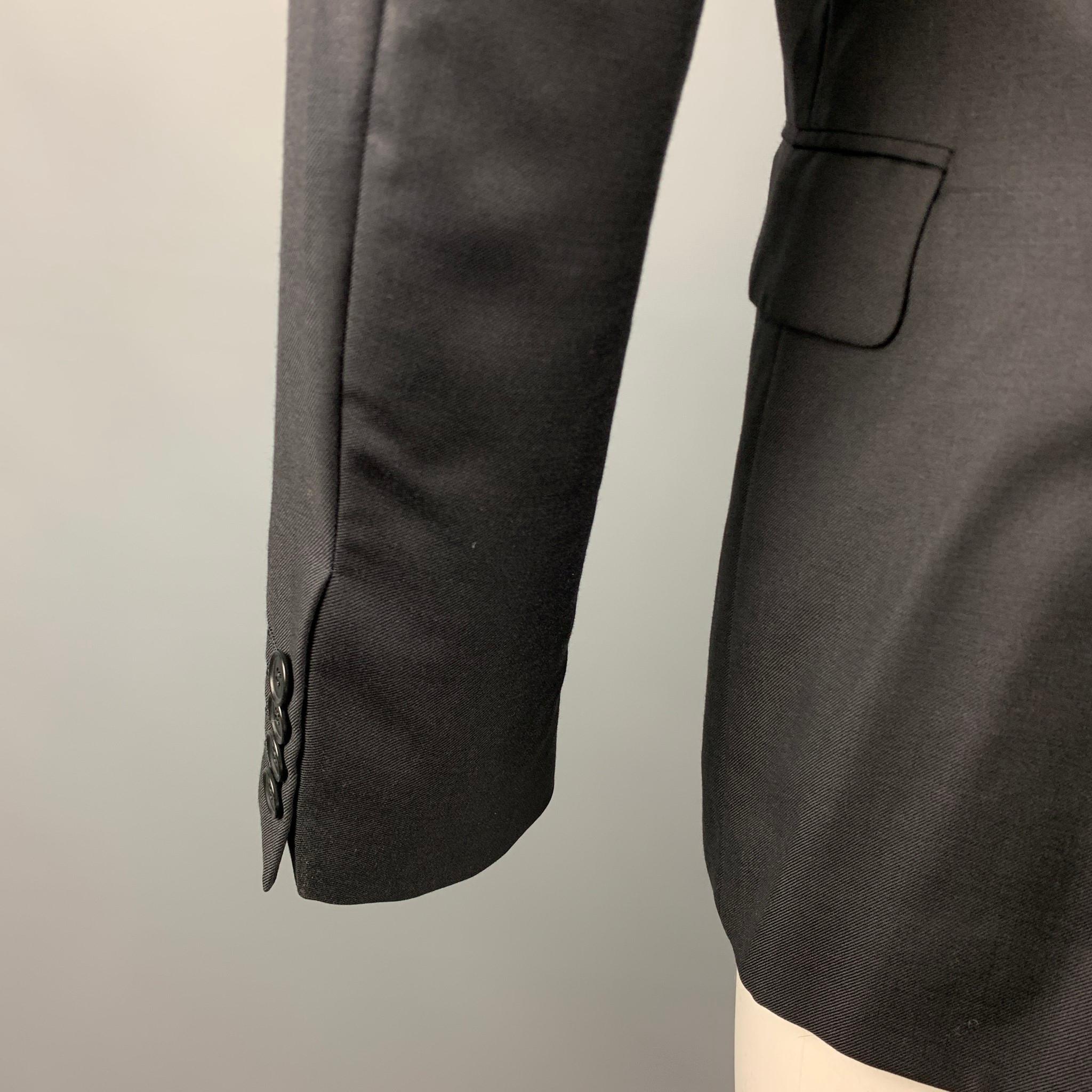 CALVIN KLEIN COLLECTION sport coat comes in a black wool / silk with a full liner featuring a notch lapel, flap pockets, and a double button closure.

Very Good Pre-Owned Condition.
Marked: 46/36

Measurements:

Shoulder: 17.5 in.
Chest: 36