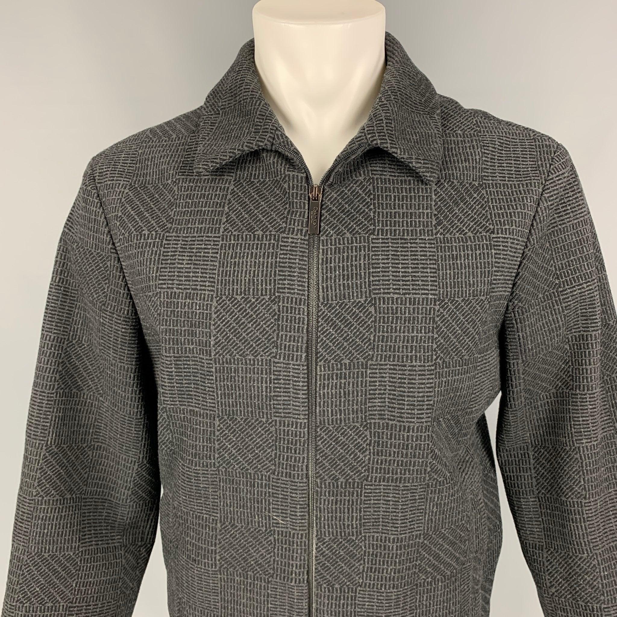 CALVIN KLEIN COLLECTION jacket comes in a charcoal & black textured wool / cashmere with a full liner featuring a spread collar, slit pockets, and a full zip up closure. Made in Italy.
Excellent
Pre-Owned Condition.  

Marked:   48 

Measurements: 
