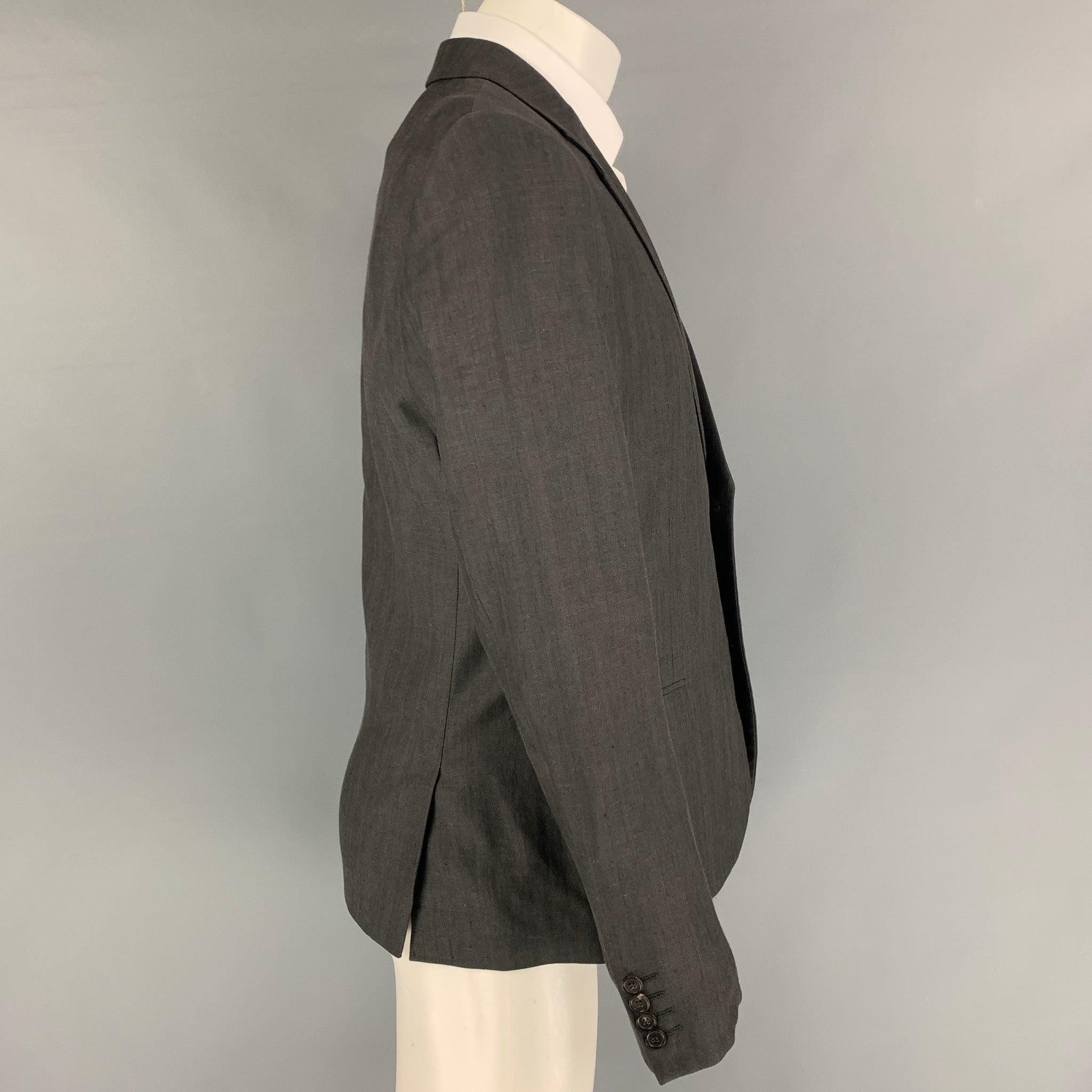 CALVIN KLEIN COLLECTION sport coat comes in a charcoal wool / linen with a full liner featuring a notch lapel, flap pockets, double back vent, and a double button closure.
Very Good
Pre-Owned Condition.  

Marked:   48/38 

Measurements: 
