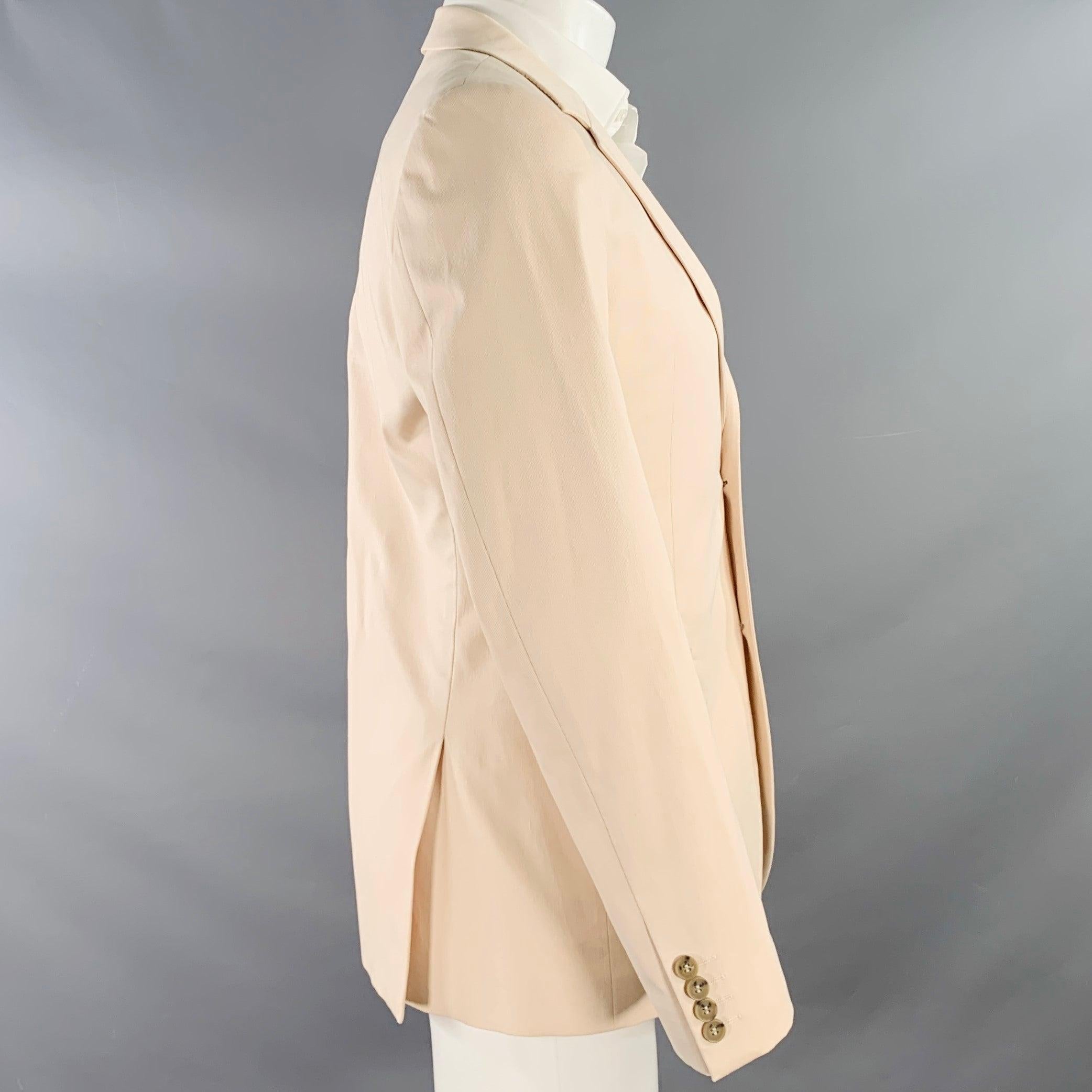 CALVIN KLEIN COLLECTION sport coat
in a cream cotton stretch blend fabric featuring a notch lapel, double vented back, and double button closure.
Made in Czech Republic.Excellent Pre-Owned Condition. 

Marked:   48/38 

Measurements: 
 
Shoulder: