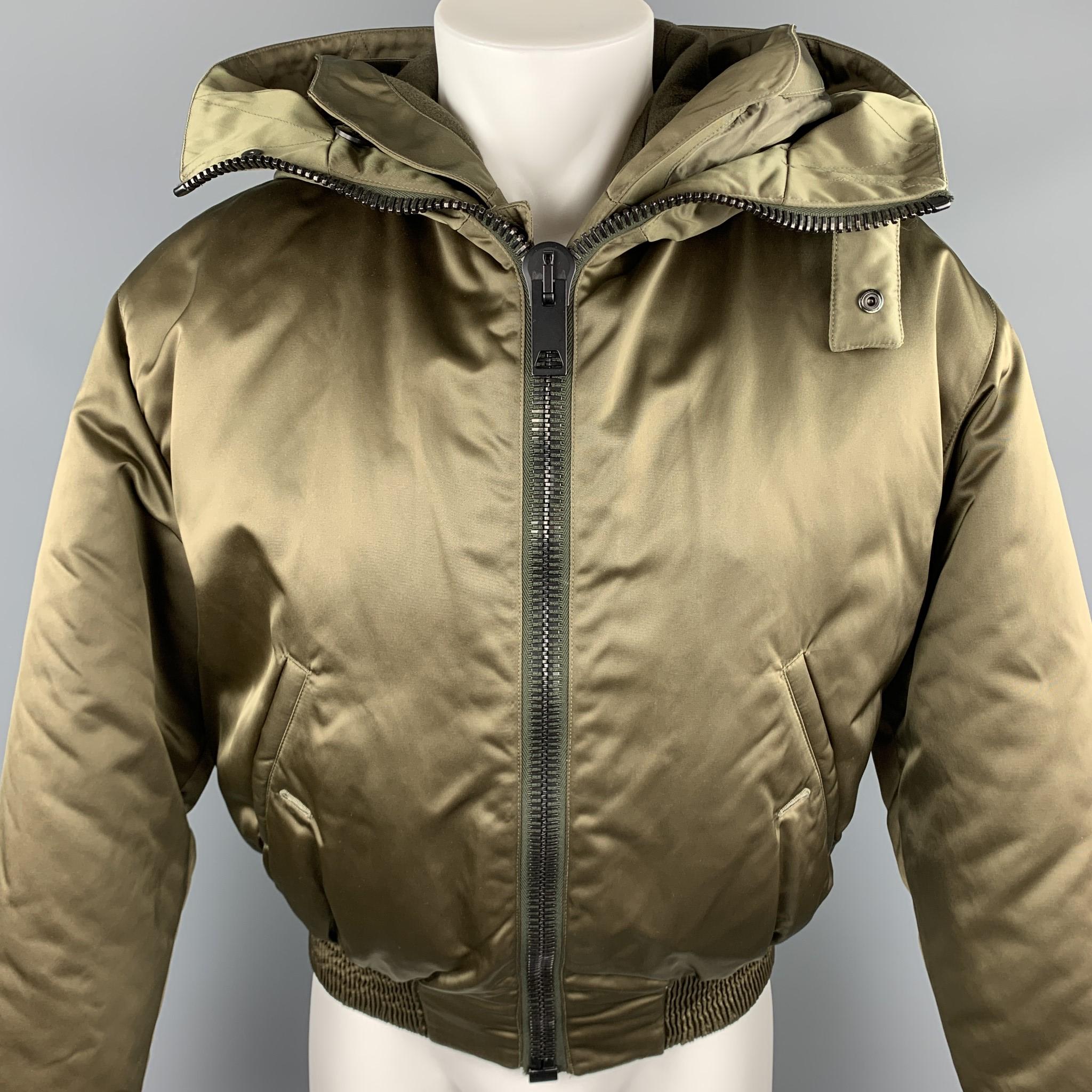 CALVIN KLEIN COLLECTION jacket comes in a olive nylon featuring a hooded style, detachable lining layer, and a chunky full zip detail closure. Made in Italy.

Excellent Pre-Owned Condition.
Marked: IT 48

Measurements:

Shoulder: 22 in. 
Chest: 46