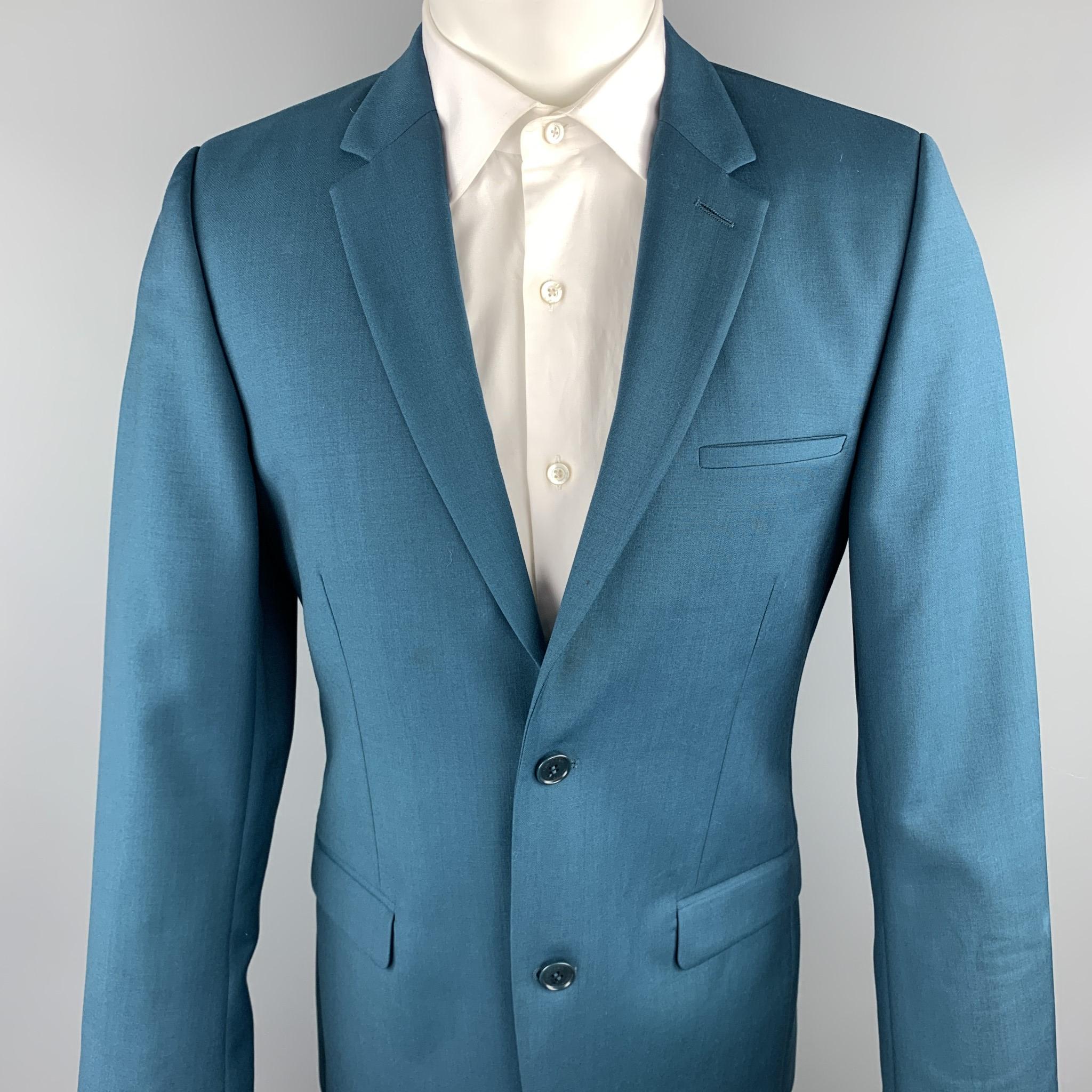 CALVIN KLEIN COLLECTION sport coat comes in a teal wool featuring a notch lapel, flap pockets, and a two button closure. Minor discoloration. As-Is.

Good Pre-Owned Condition.
Marked: 48/38

Measurements:

Shoulder: 17 in. 
Chest: 38 in. 
Sleeve:
