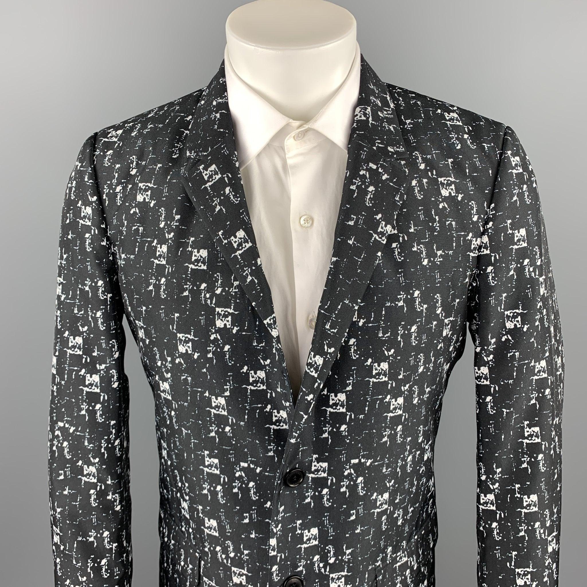 CALVIN KLEIN COLLECTION sport coat comes in a black & white print polyester with a full black liner featuring a notch lapel, flap pockets, and a two button closure.Excellent
Pre-Owned Condition. 

Marked:   48 / 38 

Measurements: 
 
Shoulder: 17.5