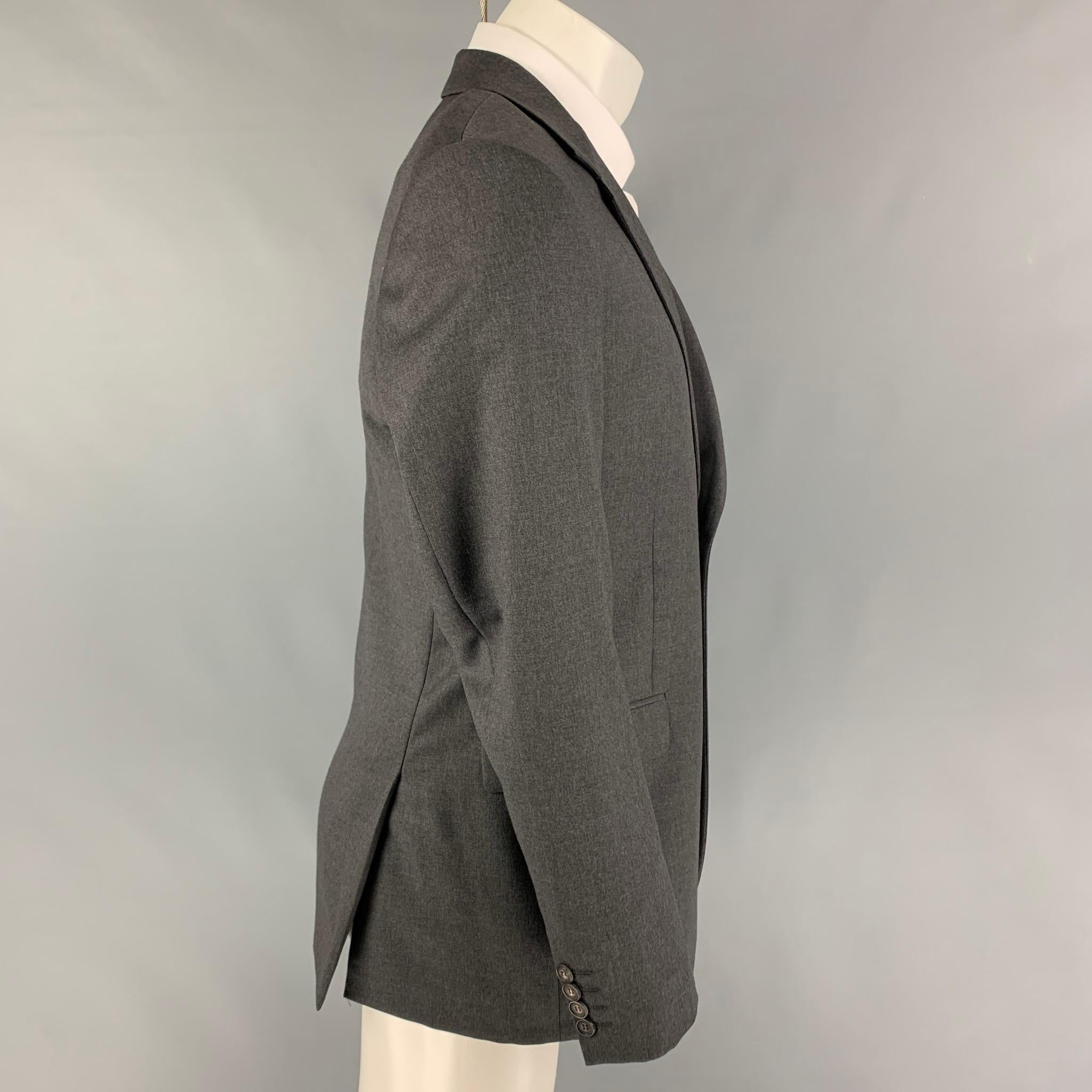 CALVIN KLEIN COLLECTION sport coat comes in a dark gray wool with a full liner featuring a notch lapel, flap pockets, double back vent, and a double button closure. 

Very Good Pre-Owned Condition.
Marked: 50/40

Measurements:

Shoulder: 18