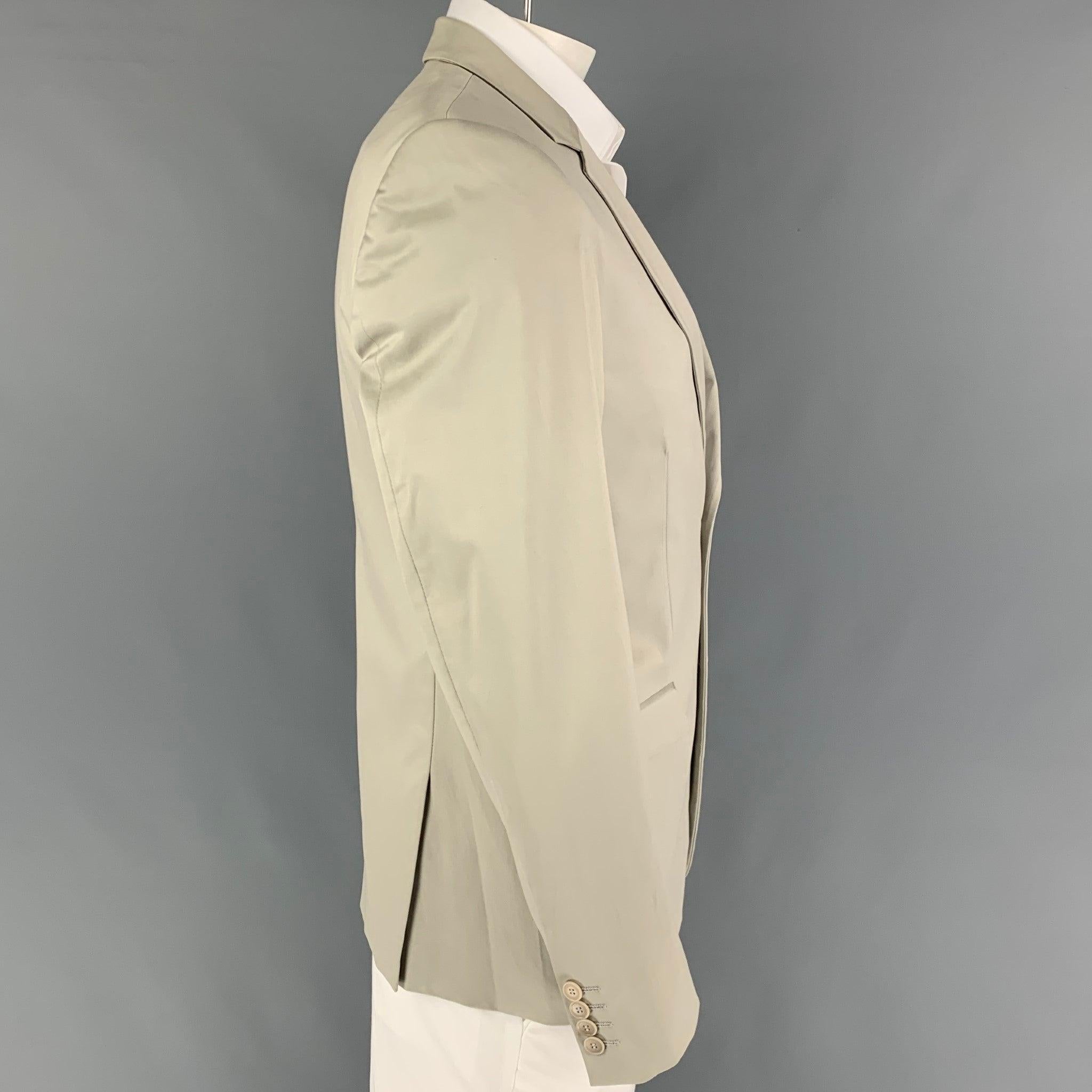 CALVIN KLEIN COLLECTION sport coat comes in a khaki cotton with a full liner featuring a notch lapel, flap pockets, double back vent, and a double button closure.
Very Good
Pre-Owned Condition. 

Marked:   50/40 

Measurements: 
 
Shoulder:
18