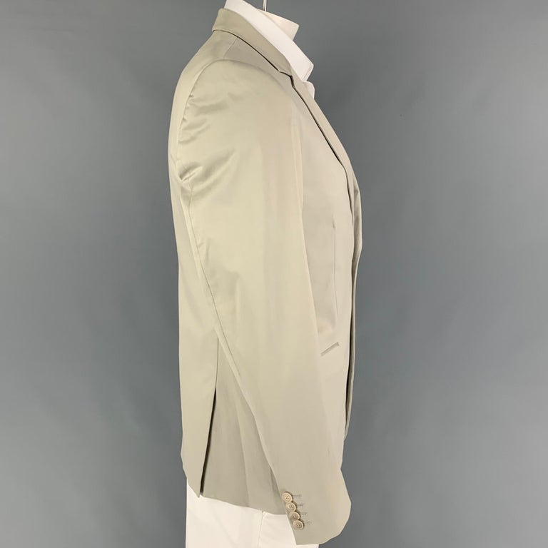CALVIN KLEIN COLLECTION sport coat comes in a khaki cotton with a full liner featuring a notch lapel, flap pockets, double back vent, and a double button closure. 

Very Good Pre-Owned Condition.
Marked: 50/40

Measurements:

Shoulder: 18 in.
Chest: