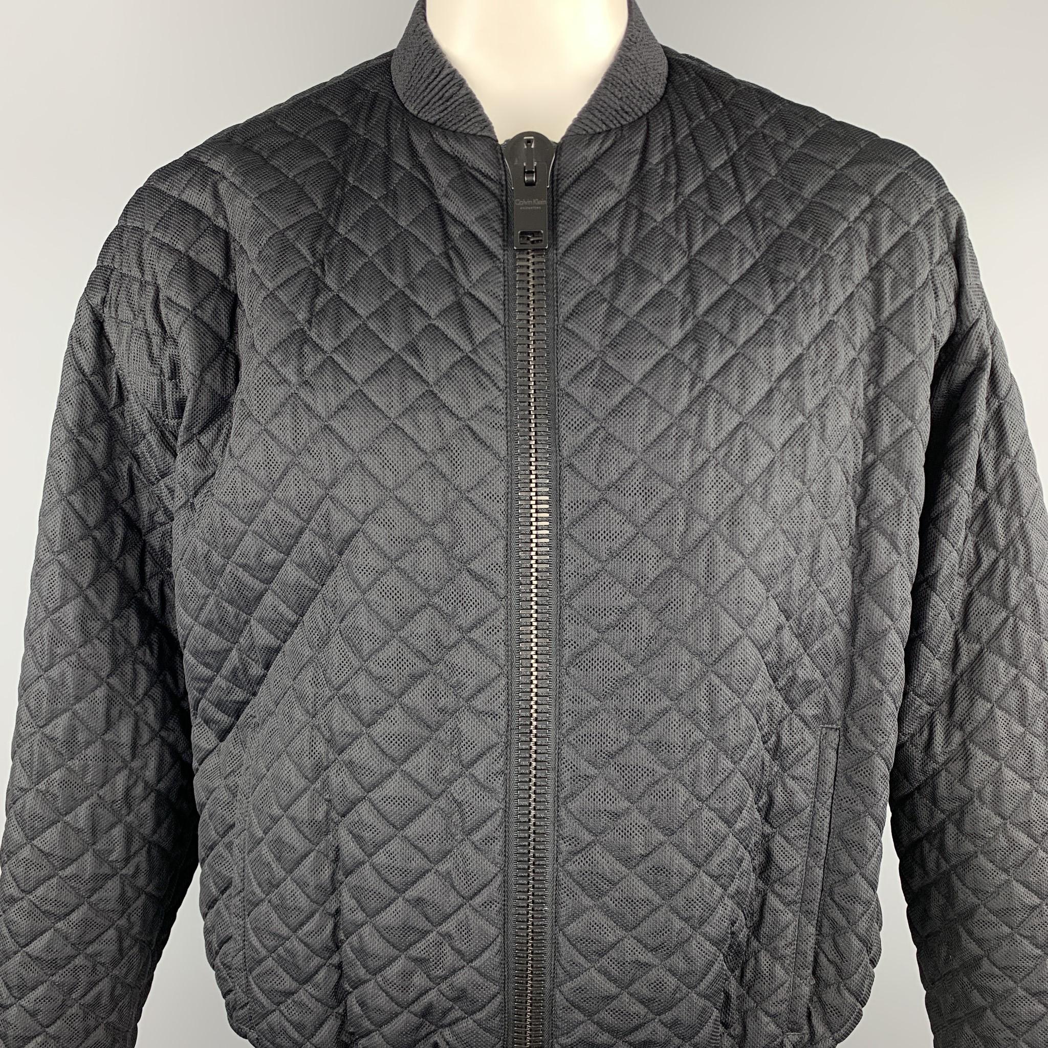 CALVIN KLEIN COLLECTION jacket comes in a black quilted nylon featuring a bomber style and a chunky zipper closure. Made in Italy.

Excellent Pre-Owned Condition.
Marked: IT 52

Measurements:

Shoulder: 23 in. 
Chest: 50 in. 
Sleeve: 25 in. 
Length: