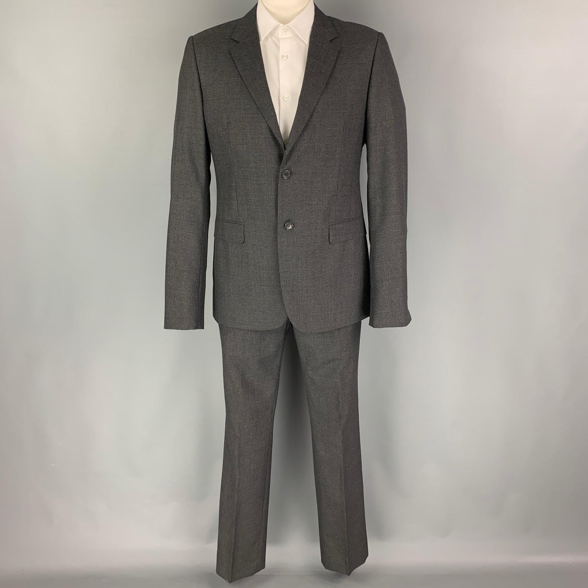 CALVIN KLEIN COLLECTION
suit comes in a charcoal wool with a full liner and includes a single breasted,
 double button sport coat with a notch lapel and matching flat front trousers. Excellent Pre-Owned Condition. 

Marked:   52/41 

Measurements: 
