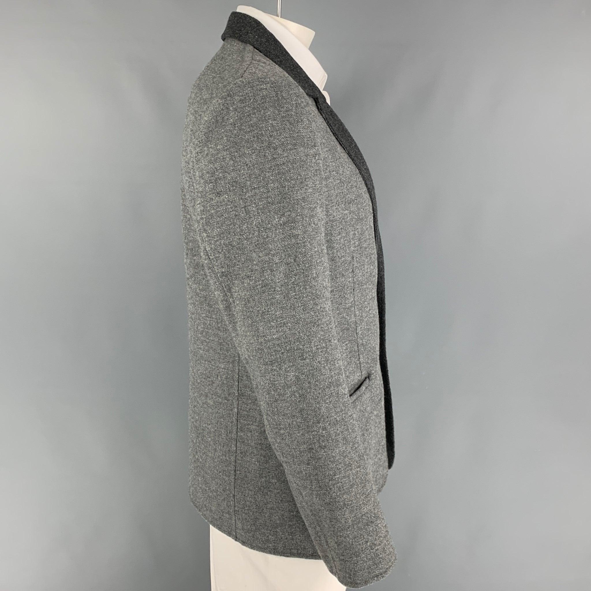 CALVIN KLEIN COLLECTION sport coat in a grey & charcoal wool featuring a notch lapel, slit pockets, single back vent, and a double button closure. Made in Italy.
Excellent
Pre-Owned Condition. 

Marked:   52/42 

Measurements: 
 
Shoulder: 18.5