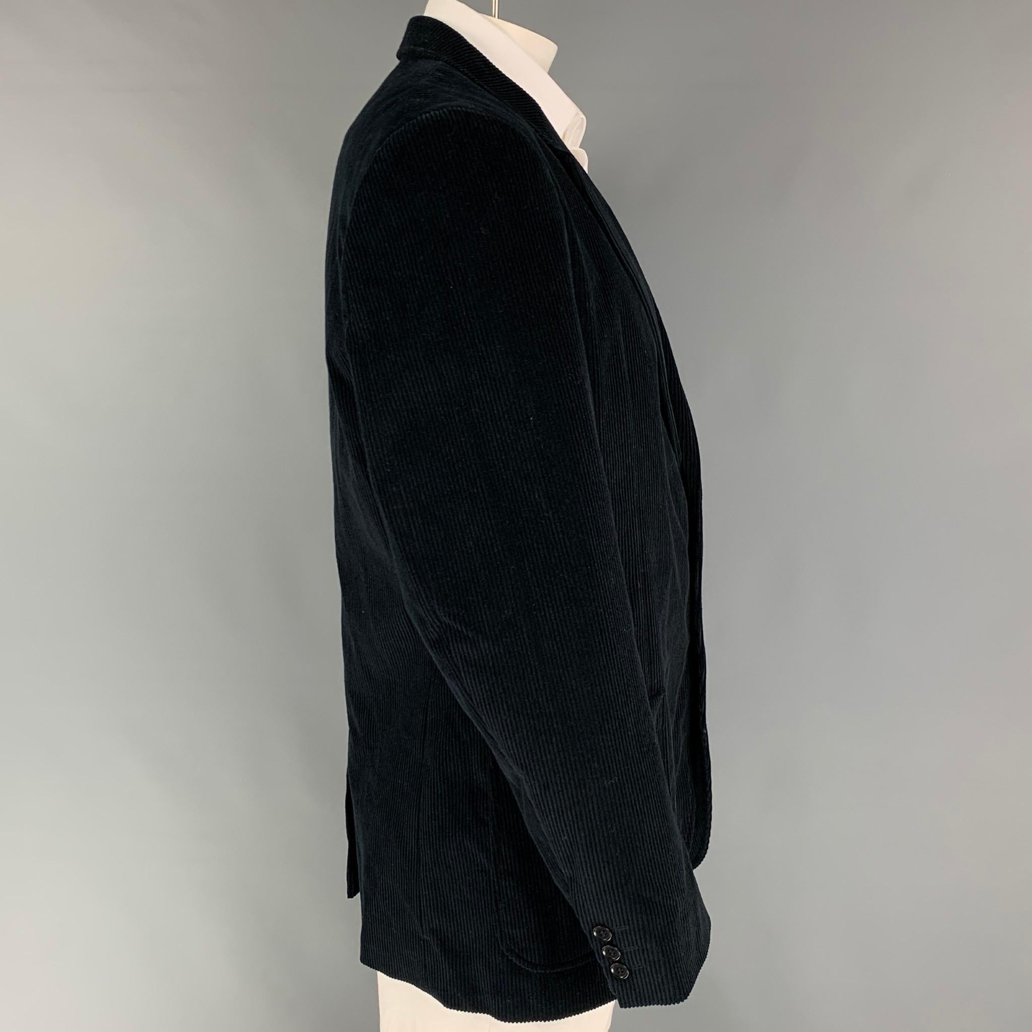 CALVIN KLEIN sport coat comes in a black corduroy cotton with a full liner featuring a notch lapel, patch pockets, single back vent, and a double button closure. Made in Italy. 

Very Good Pre-Owned Condition.
Marked:
