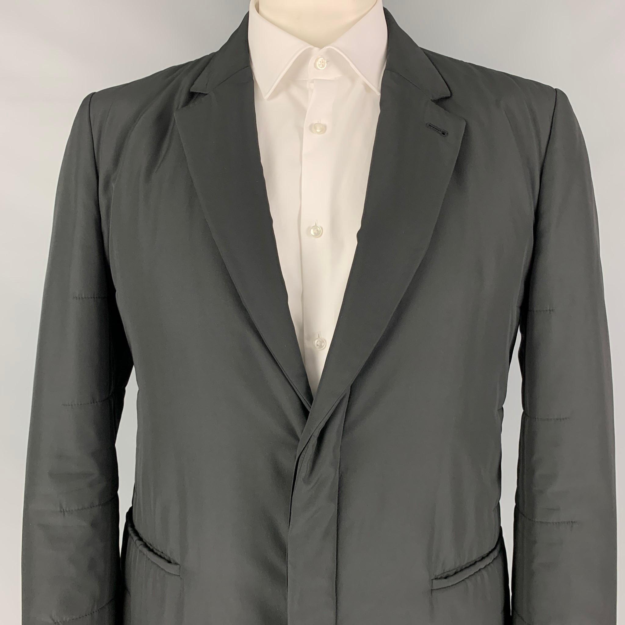 CALVIN KLEIN COLLECTION sport coat comes in a black quilted polyester with a full liner featuring a notch lapel, slit pockets, and a hidden double button closure. 

Excellent Pre-Owned Condition.
Marked: 54

Measurements:

Shoulder: 18.5 in.
Chest: