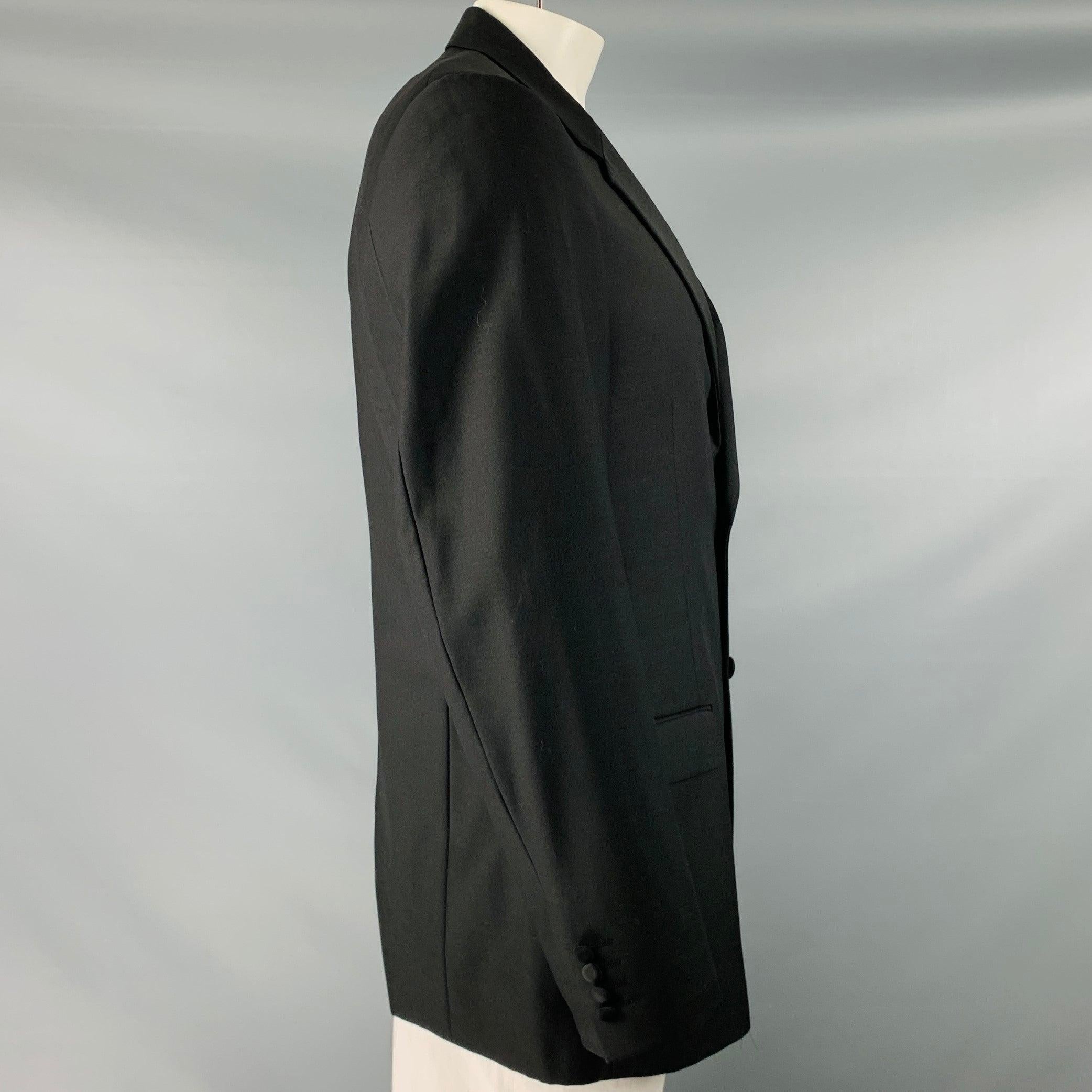 CALVIN KLEIN COLLECTION sport coat
in a black wool fabric featuring notch lapel, single vented back, and double button closure. Made in Czech Republic.Very Good Pre-Owned Condition. Minor marks. 

Marked:   54 

Measurements: 
 
Shoulder: 18 inches