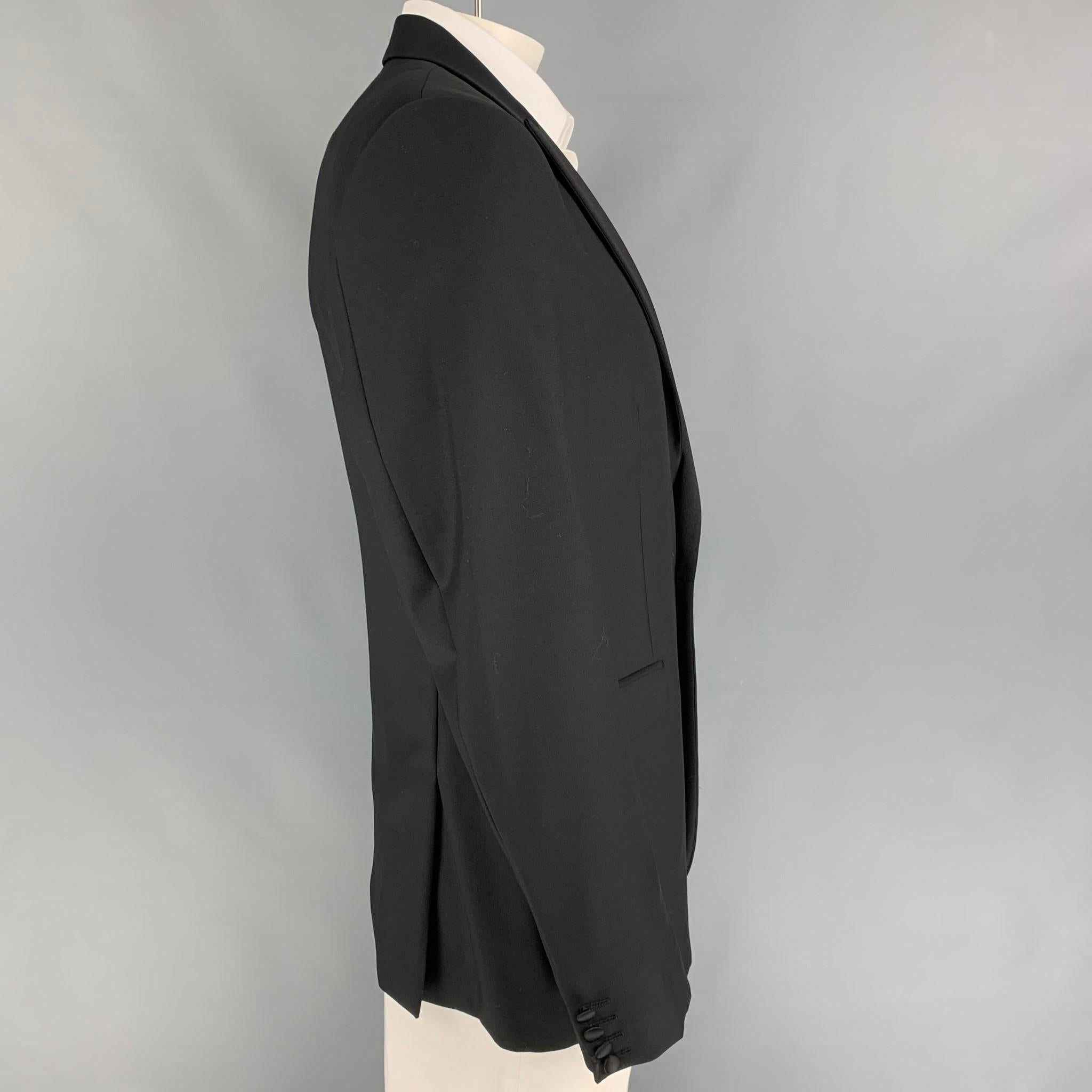 CALVIN KLEIN COLLECTION sport coat comes in a black wool with a full liner featuring a peak lapel, flap pockets, double back vent, and a single button closure. 

Very Good Pre-Owned Condition.
Marked: 54/44

Measurements:

Shoulder: 18.5 in.
Chest: