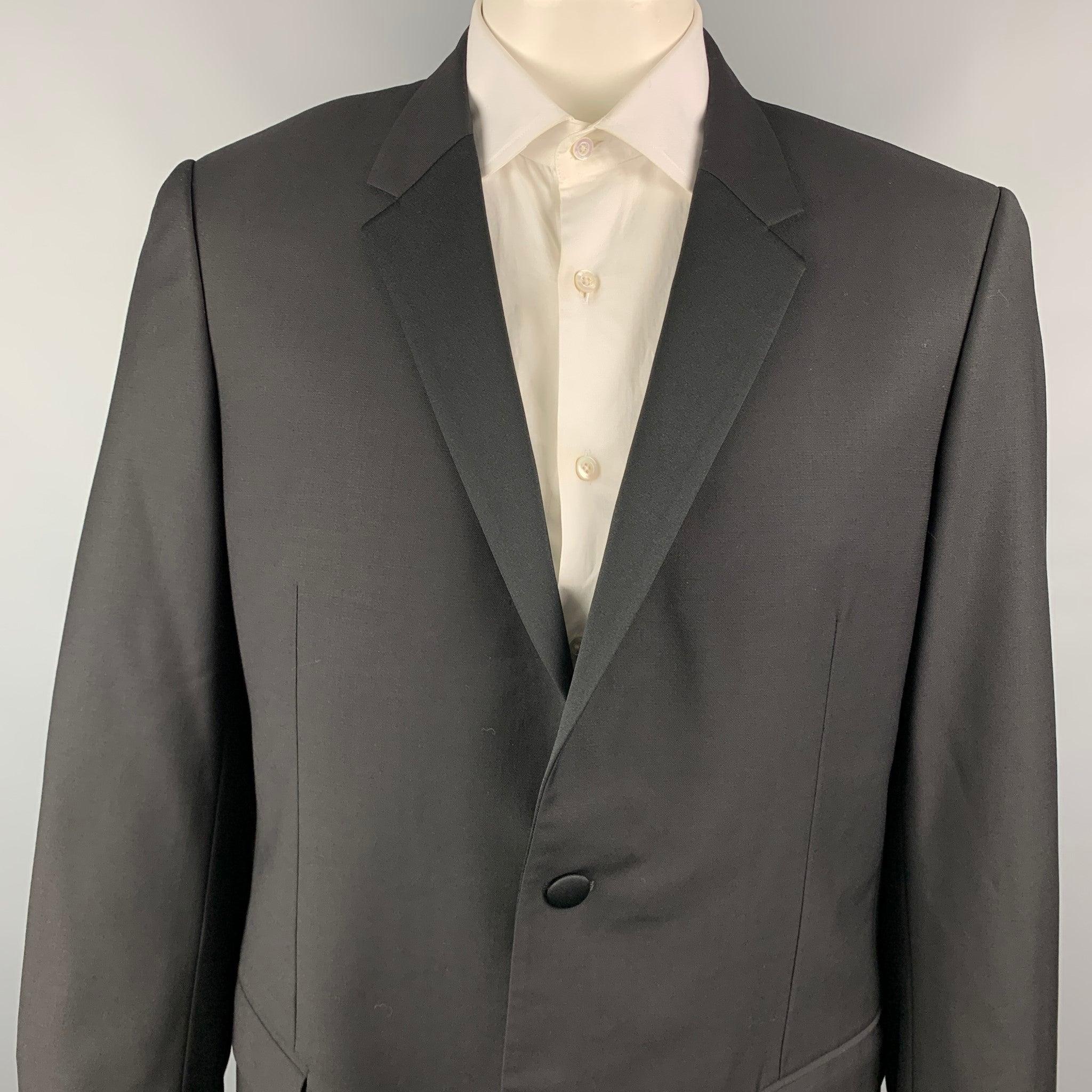 CALVIN KLEIN COLLECTION tuxedo sport coat comes in a black wool with a full liner featuring a notch lapel, flap pockets, and a double button closure. Very Good Pre-Owned Condition. 

Marked:   44/54 

Measurements: 
 
Shoulder: 19 inches  Chest: 44