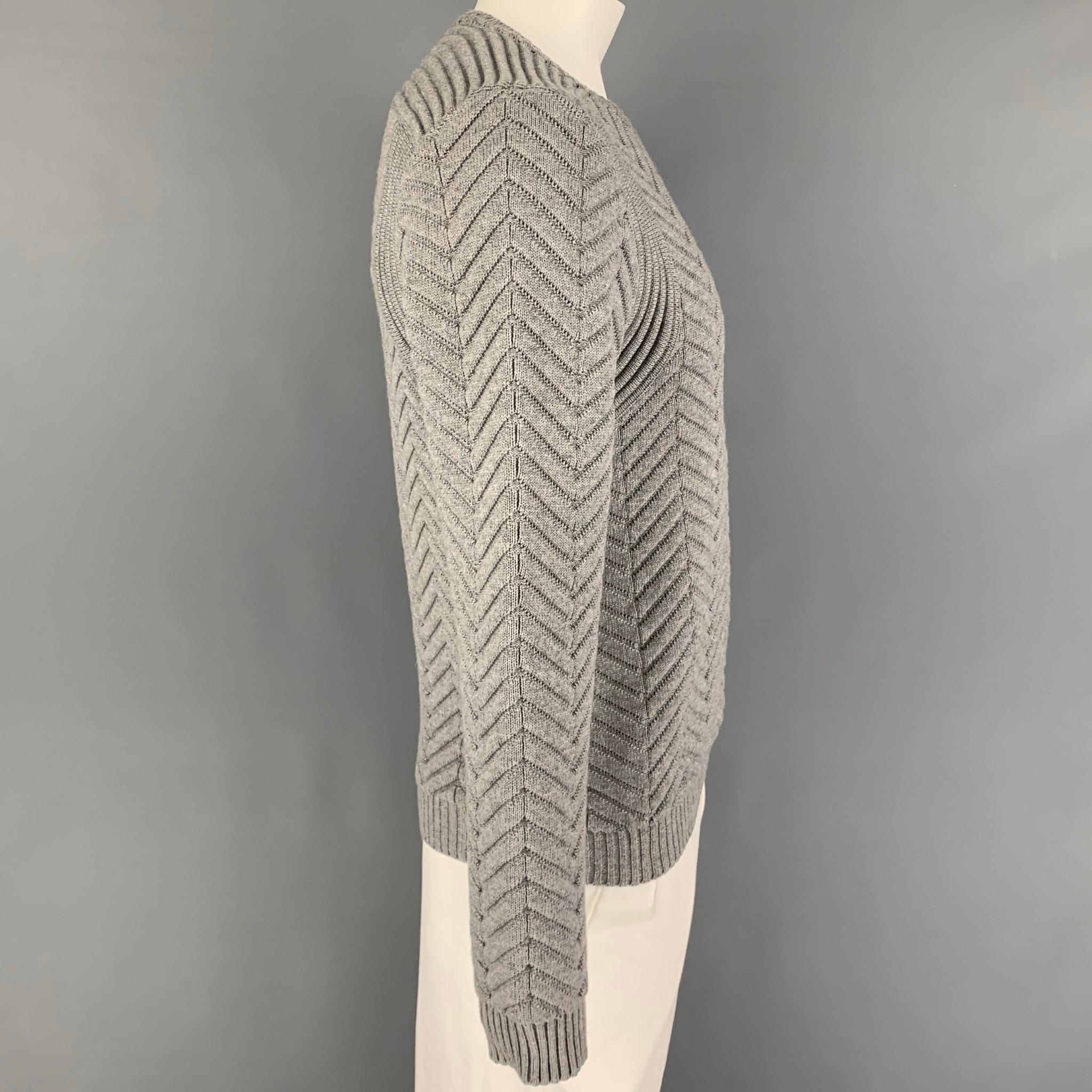 CALVIN KLEIN COLLECTION sweater comes in a grey chevron knitted material featuring a crew-neck. Made in Italy. 

Excellent Pre-Owned Condition.
Marked: L

Measurements:

Shoulder: 18.5 in.
Chest: 40 in.
Sleeve: 27 in.
Length: 26.5 in.