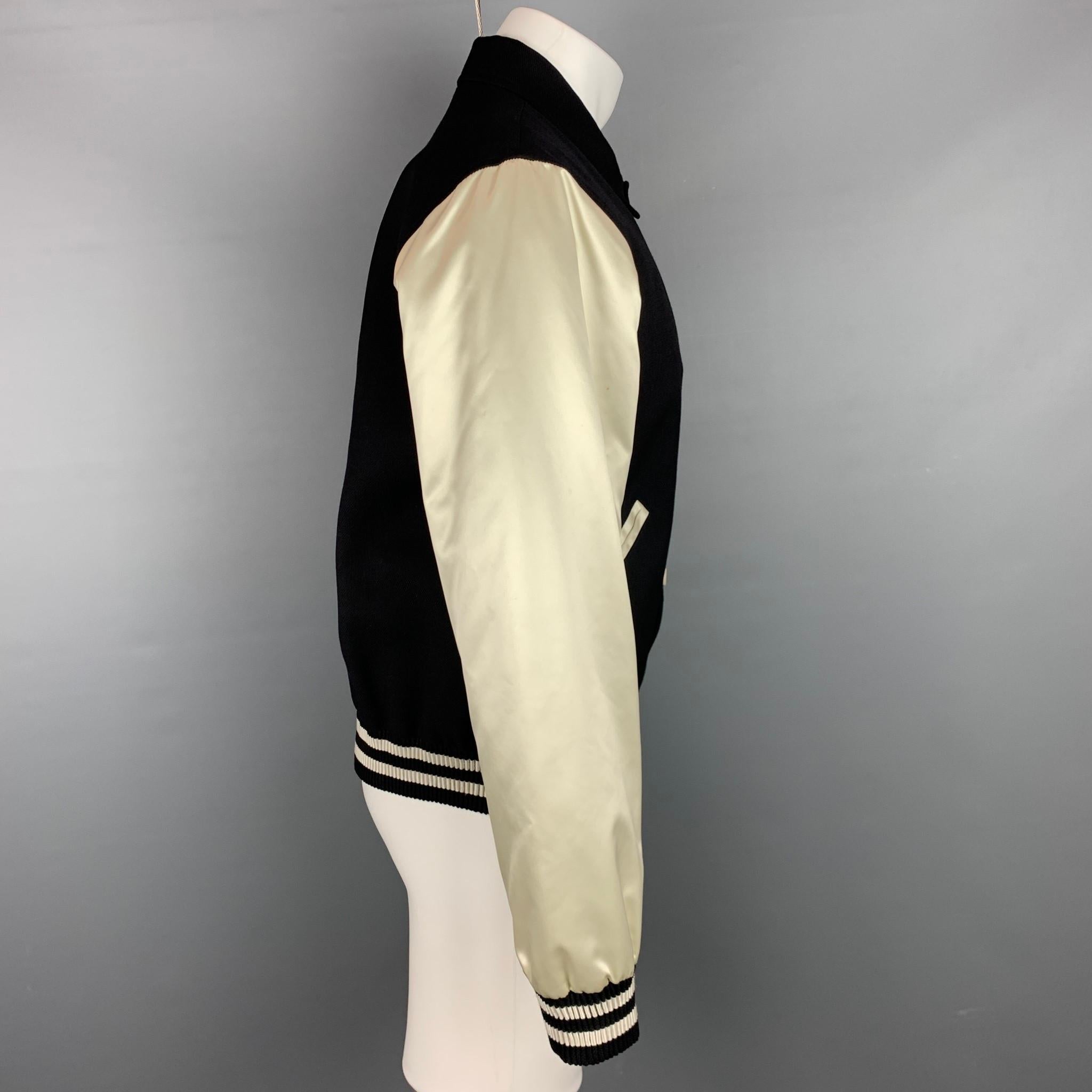 CALVIN KLEIN COLLECTION jacket comes in a black wool blend with beige sleeves featuring a ribbed hem, slit pockets, pointed collar, and a snap button closure. Minor discoloration. Made in Italy.

Very Good Pre-Owned Condition.
Marked: