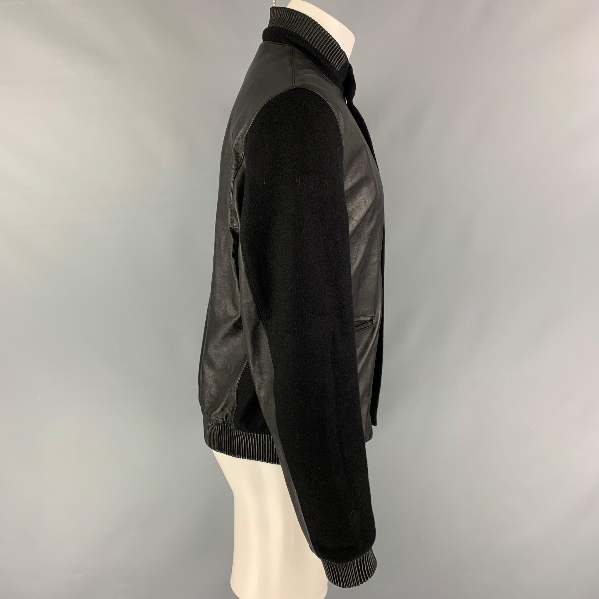 CALVIN KLEIN COLLECTION jacket comes in a black leather with a quilted liner featuring a bomber style, ribbed hem, front slit pockets, and a hidden zip & snap button closure. 

Excellent Pre-Owned Condition.
Marked: 50 /