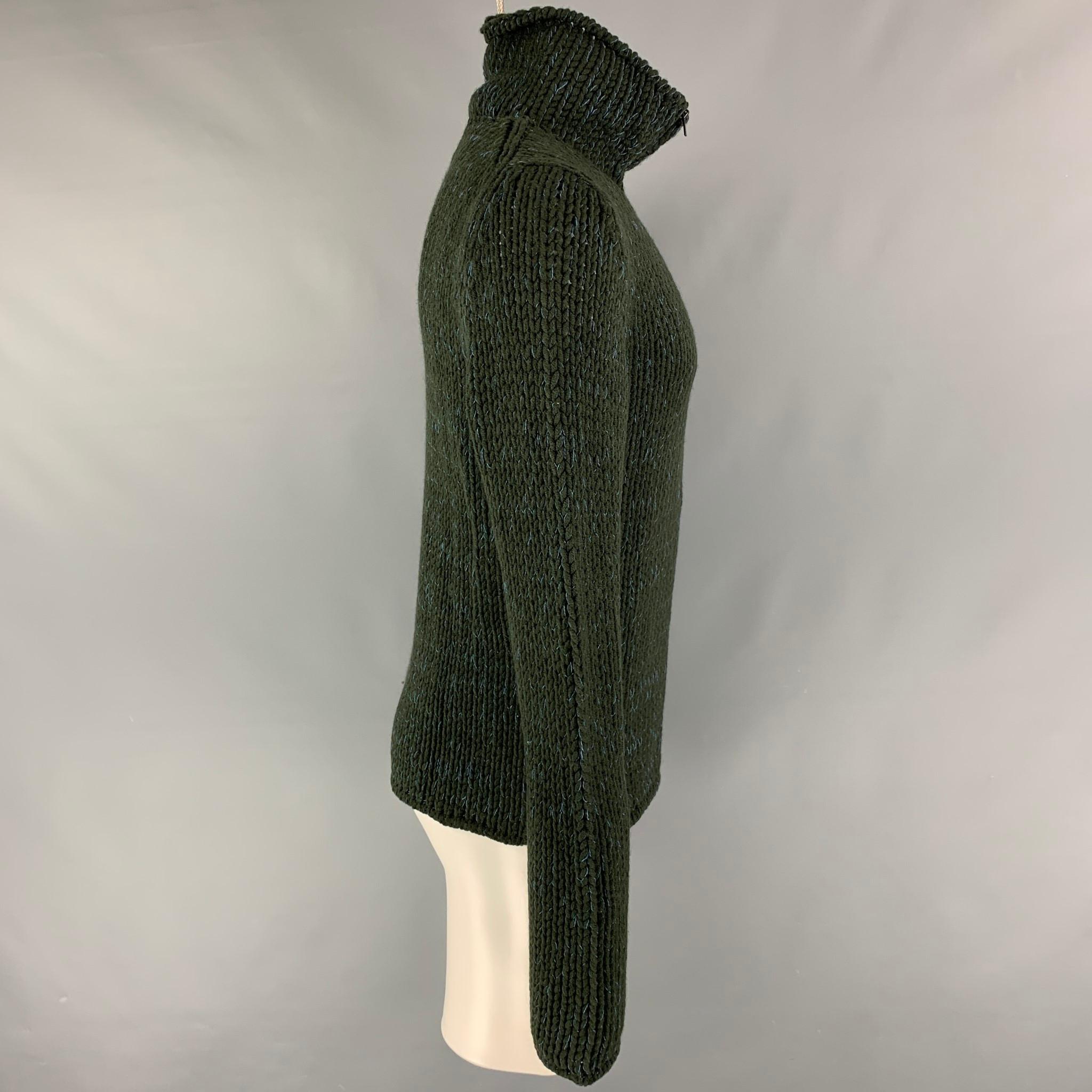 CALVIN KLEIN COLLECTION cardigan comes in a green & blue wool blend featuring a high collar and a zip up closure. Made in Italy.

Excellent Pre-Owned Condition.
Marked: M

Measurements:

Shoulder: 17 in.
Chest: 38 in.
Sleeve: 32 in.
Length: 26.5 in. 