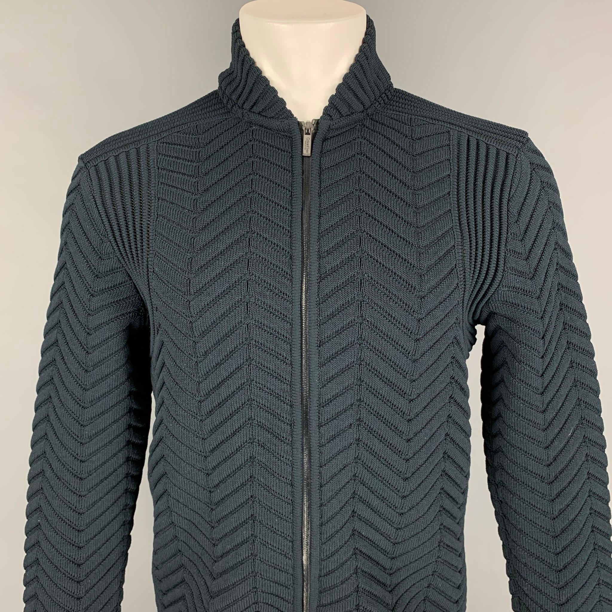 CALVIN KLEIN COLLECTION jacket comes in a navy knitted polyester featuring a stand up collar and a full zip up closure. Made in Italy. 

Very Good Pre-Owned Condition.
Marked: M

Measurements:

Shoulder: 18 in.
Chest: 38 in.
Sleeve: 29 in.
Length: