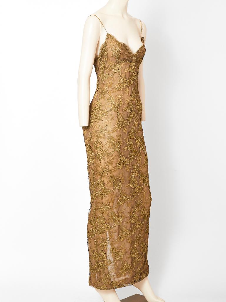 Calvin Klein, bronze tone, metallic lace, body hugging, slip gown, having a nude silk chiffon lining. 
Hidden zipper side closure. From the Calvin Klein era C. 1979-80.