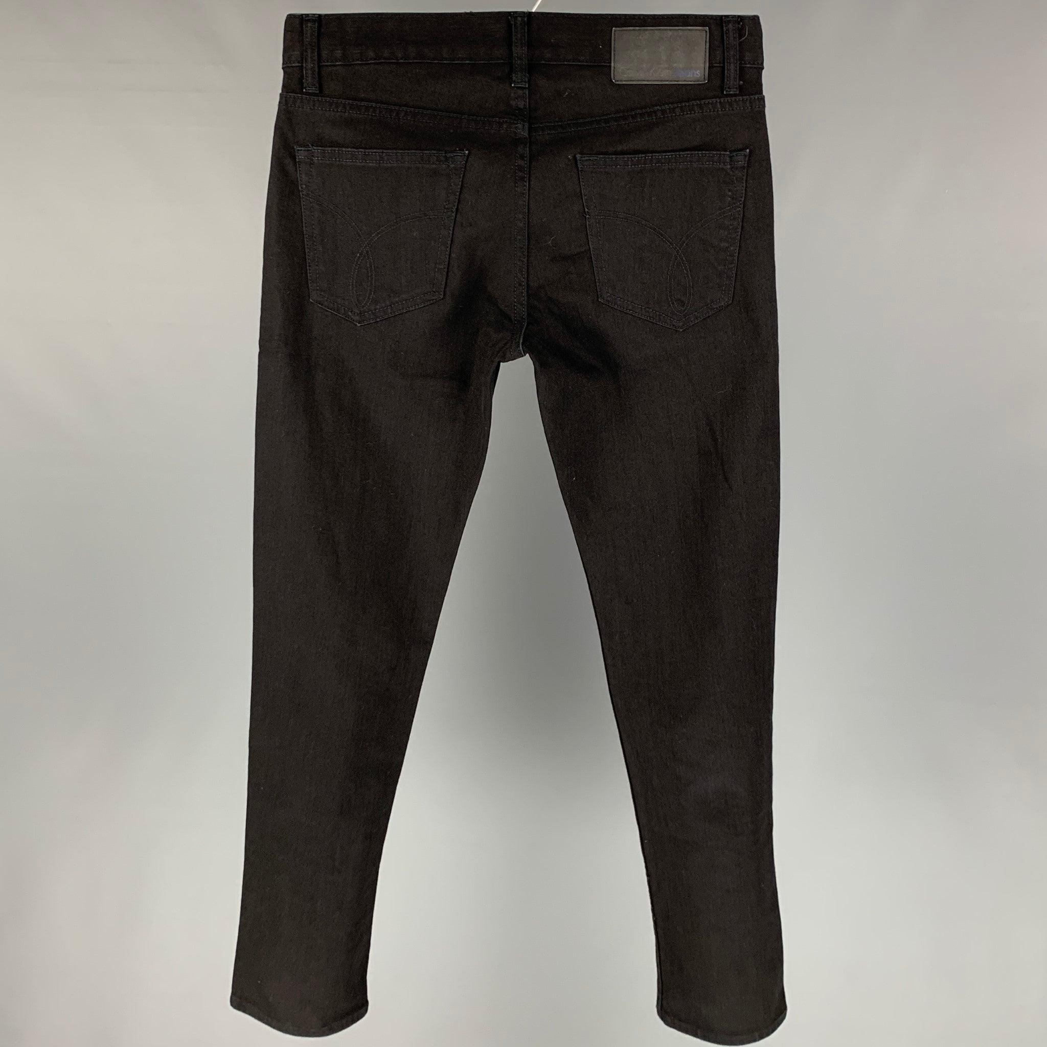 CALVIN KLEIN jeans comes in a black cotton featuring a slim fit and a zip fly closure.
 Very Good
 Pre-Owned Condition. 
 

 Marked:  31x30 
 

 Measurements: 
  Waist: 31 inches Rise: 10 inches Inseam: 31 inches 
  
  
  
 Sui Generis Reference: