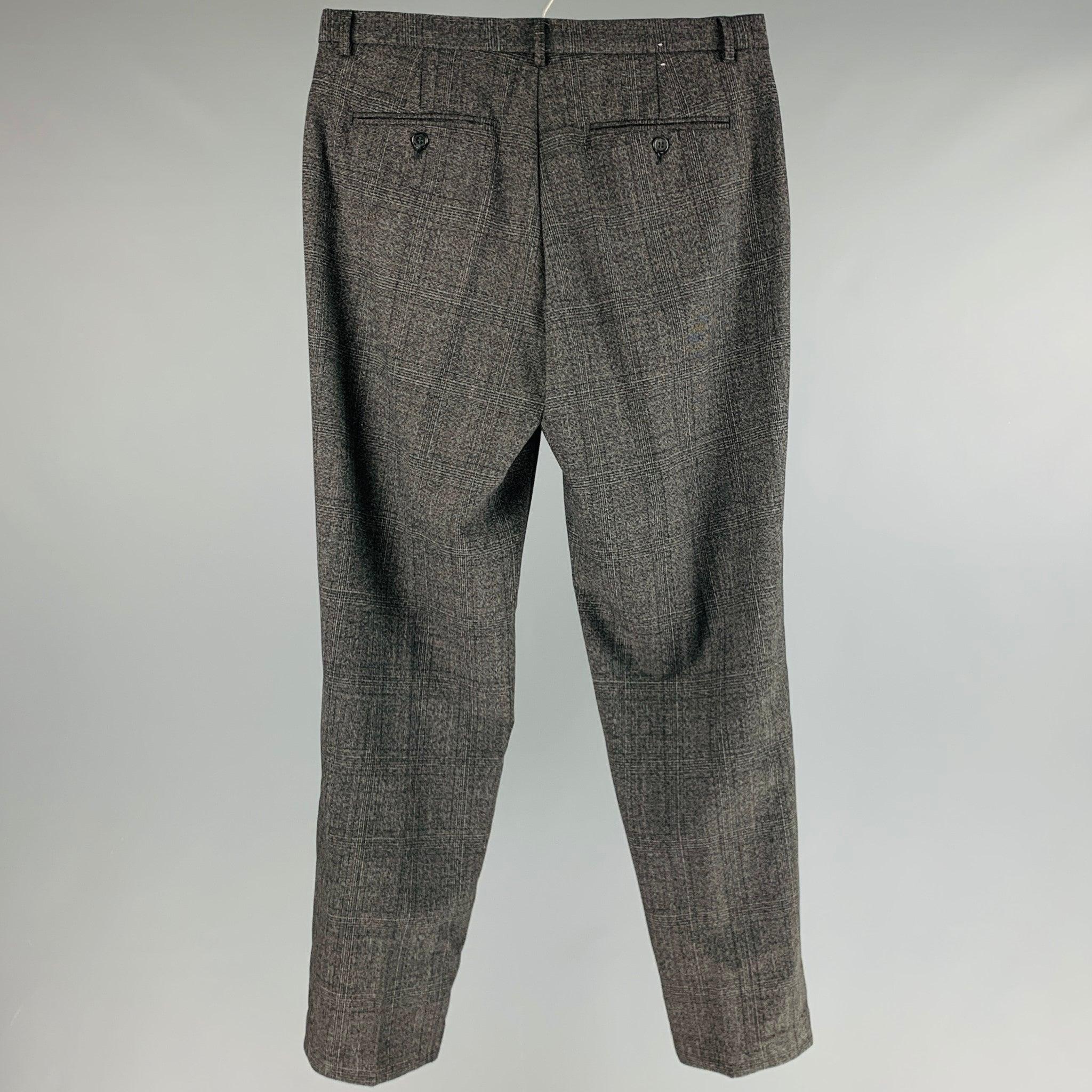CALVIN KLEIN pants comes in a faded black and grey glenplaid wool and polyester blend woven featuring a high waist, regular fit, and a zip fly closure.Excellent Pre-Owned Condition. 

Marked:   32 

Measurements: 
  Waist: 32 inches Rise: 9.5 inches