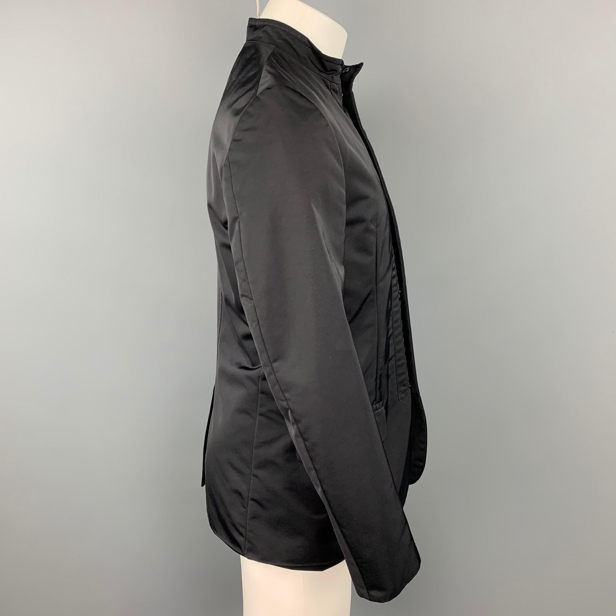 CALVIN KLEIN jacket comes in a black polyamide featuring top stitching, flap pockets, and a hidden snap button closure. Made in Italy.

Very Good Pre-Owned Condition.
Marked: 46 / 36

Measurements:

Shoulder: 17 in.
Chest: 38 in.
Sleeve: 25