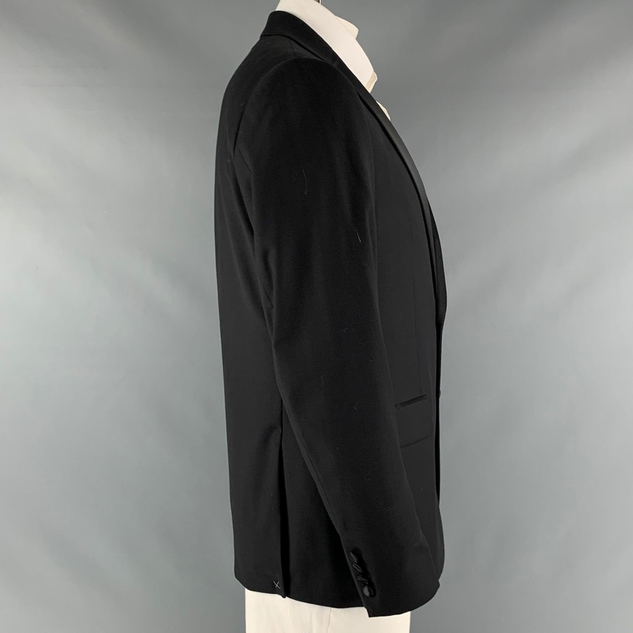CALVIN KLEIN x SLIM FIT tuxedo sport coat comes in a black wool stretch material with a full liner and includes a single breasted, double button closure, notch lapel and double back vent.New with Tags. 

Marked:   42 R 

Measurements: 
 
Shoulder: