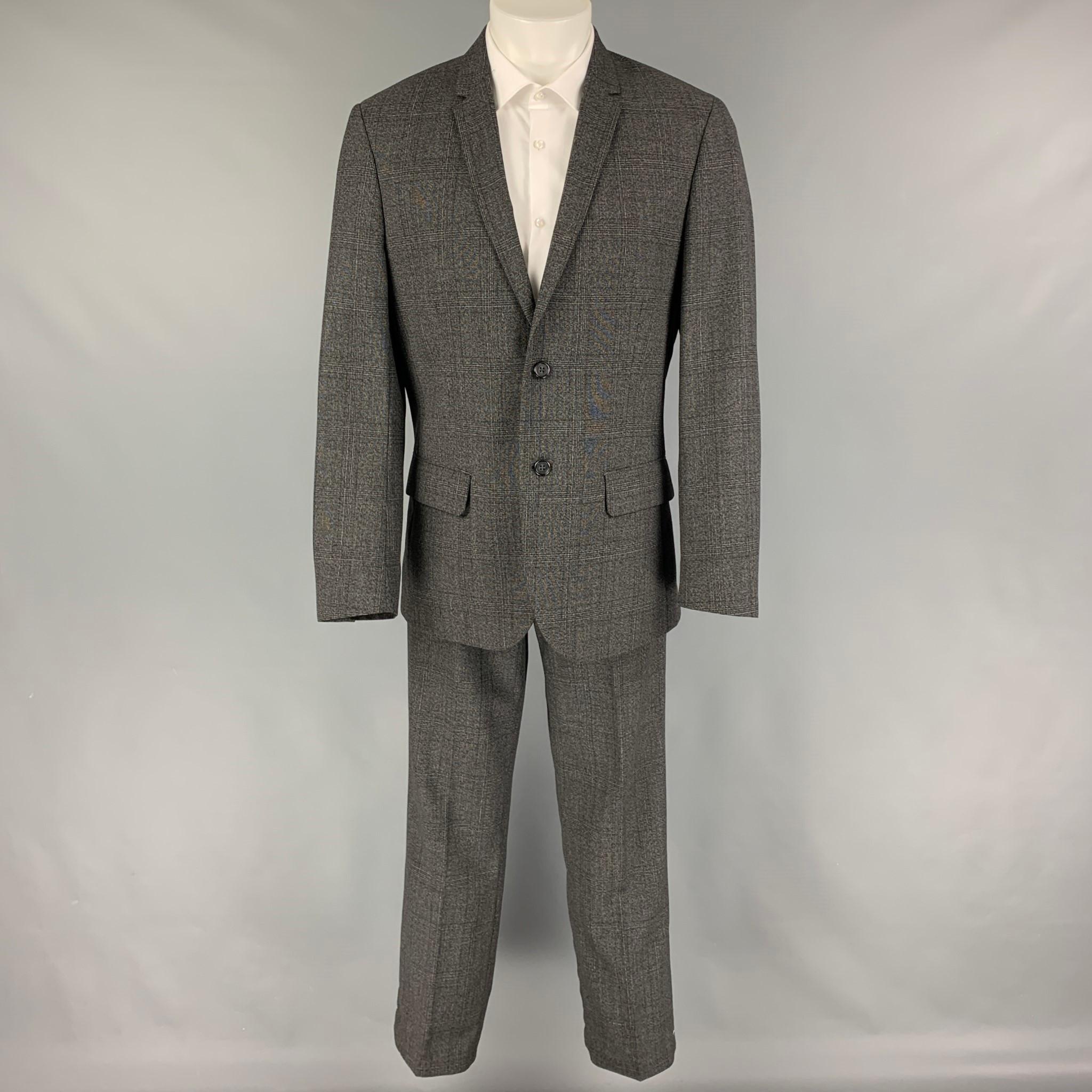 CALVIN KLEIN suit comes in a grey plaid wool with a full liner and includes a singe breasted, double button sport coat with a notch lapel and matching flat front trousers.

Very Good Pre-Owned Condition.
Marked: M

Measurements:

-Jacket
Shoulder:
