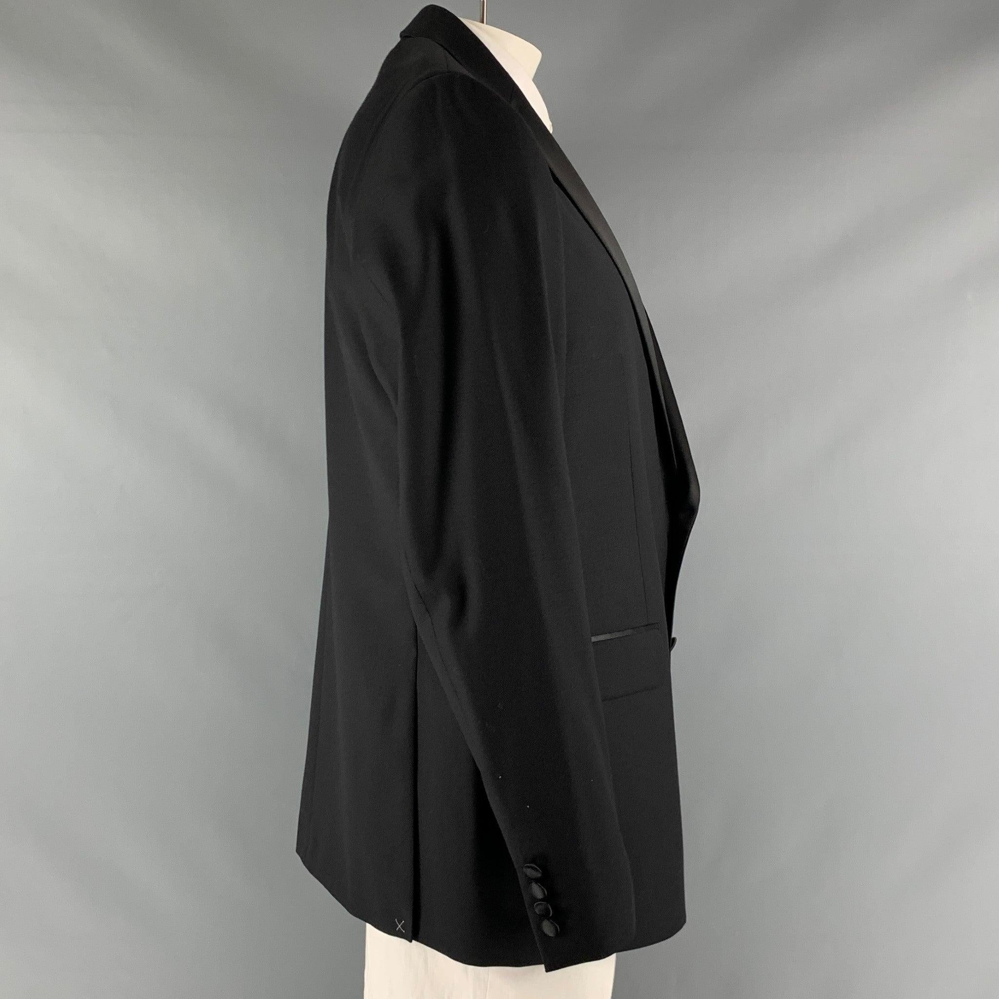 CALVIN KLEIN x SLIM FIT tuxedo sport coat comes in a black wool stretch material with a full liner and includes a single breasted, double button closure, notch lapel and double back vent.New with Tags. 

Marked:   46 L 

Measurements: 
 
Shoulder: