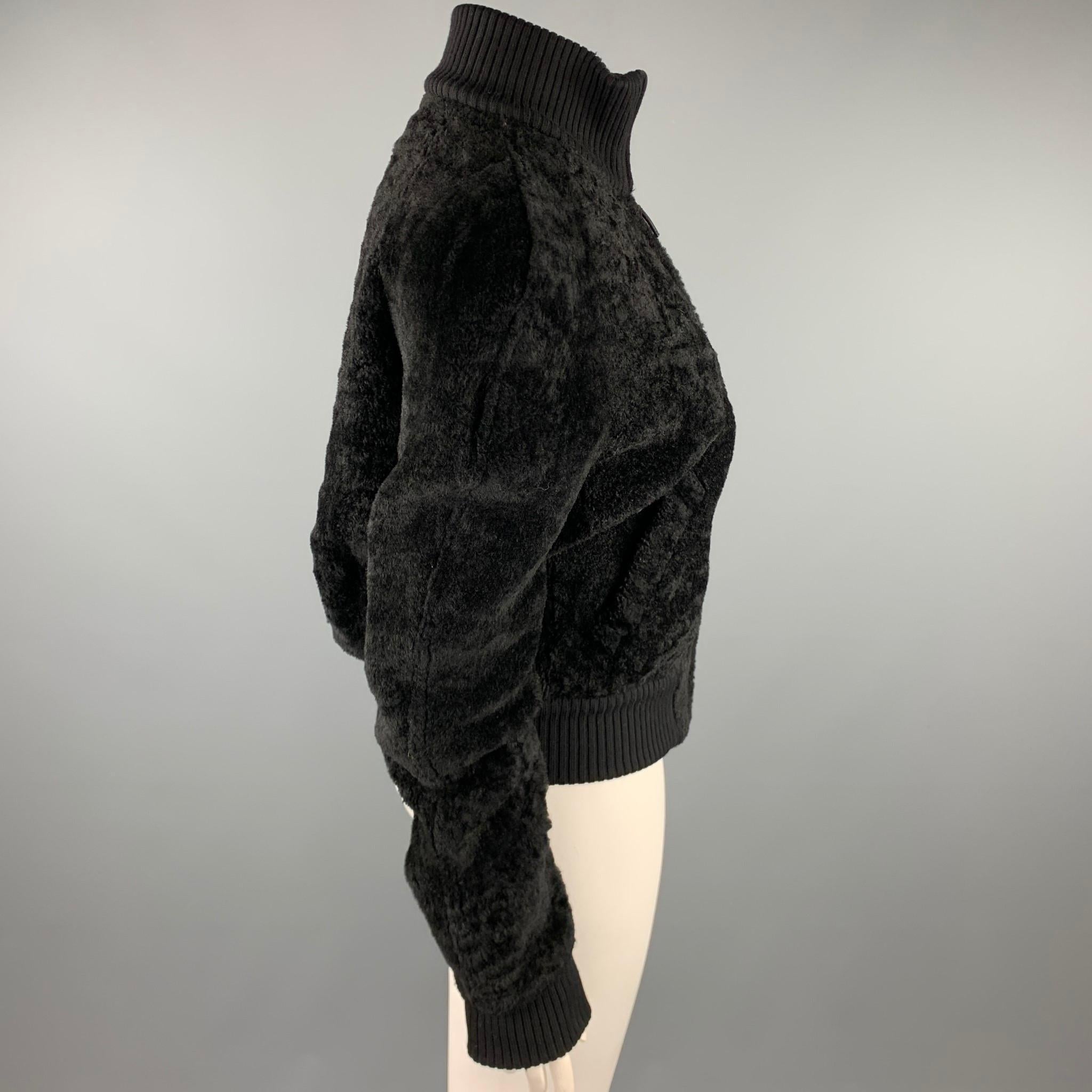 CALVIN KLEIN jacket comes in a black textured shearling leather featuring a high collar, ribbed trim, slit pockets, and a zip up closure. Made in Italy.

Very Good Pre-Owned Condition.
Marked: 8

Measurements:

Shoulder: 18 in. 
Bust: 42 in.