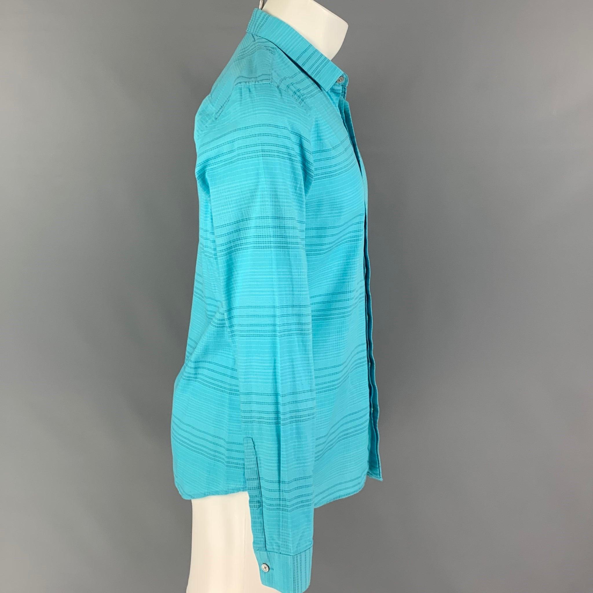 CALVIN KLEIN long sleeve shirt comes in a aqua grid cotton featuring a extra slim fit, spread collar, and a hidden placket closure.
Very Good
Pre-Owned Condition. 

Marked:   M  

Measurements: 
 
Shoulder:
16.5 inches  Chest: 38 inches  Sleeve: 26